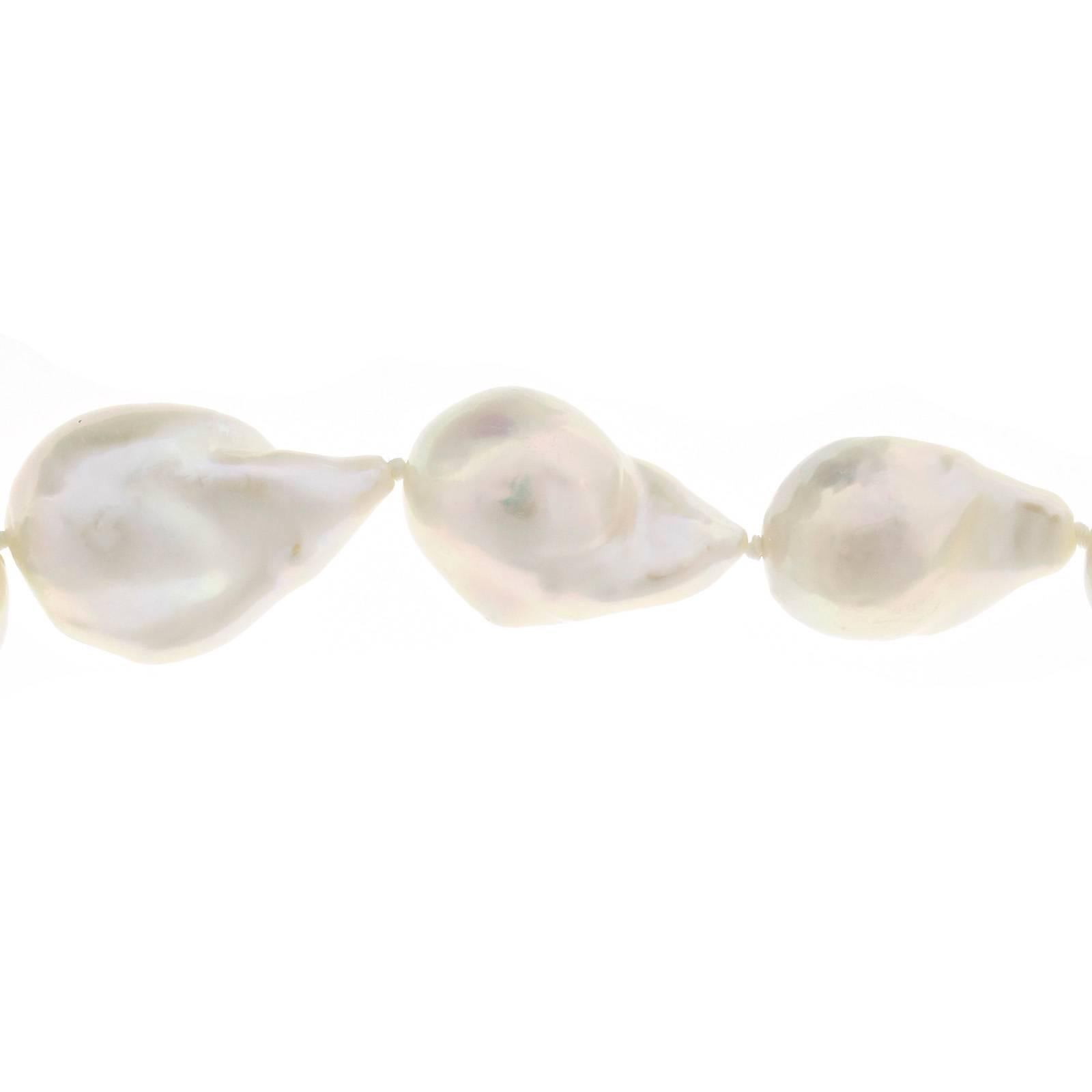 Large size Chinese extra fine white iridescent high lustre baroque cultured pearls strung to a yellow gold 3-D catch. 

19 fine white Chinese freshwater baroque pearls, from 19.96 x 14.66mm to 26.28 x 17.54mm, excellent lustre and iridescent
14k