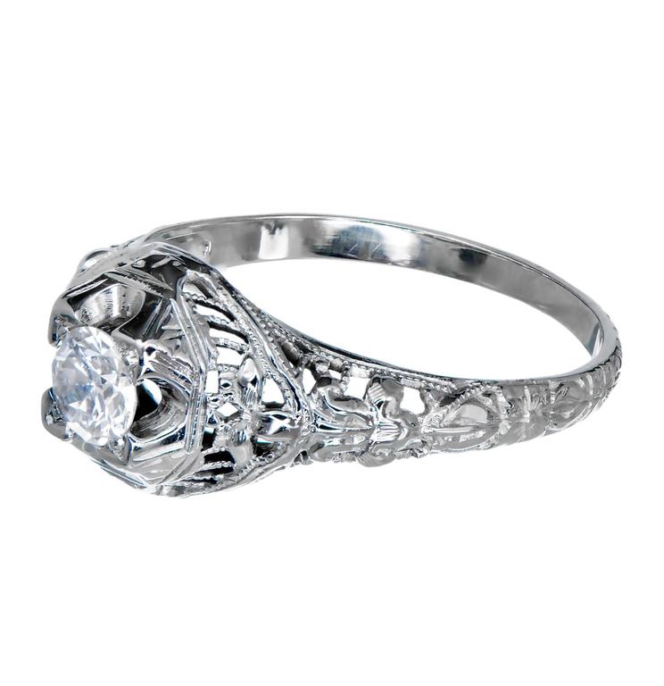 1940 18k white gold filigree engagement ring with a transitional old European cut diamond in its original setting.

1 round diamond¸ approx. total weight .25cts, H, VS2
18k white gold
Tested and stamped: 18k
Hallmark: R.S.
2.0 grams
Width at top: