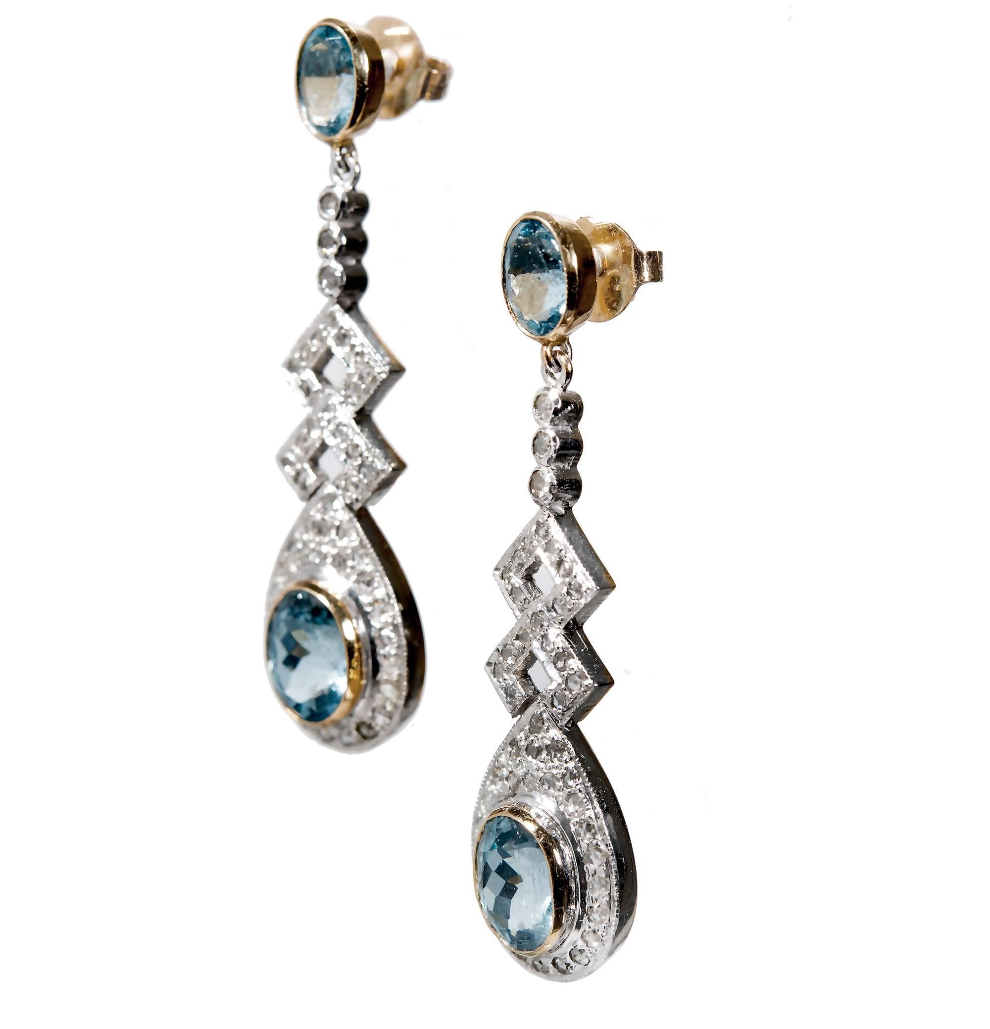 1930's Aqua and diamond dangle drop earrings.  18k yellow gold base, posts and friction backs and silver tops. 4 oval aquas with 110 rose cut accent diamonds. 

2 oval fine blue Aquamarine, approx. total weight 4.30cts, SI, 8.96 x 6.79 x 5.16mm
110