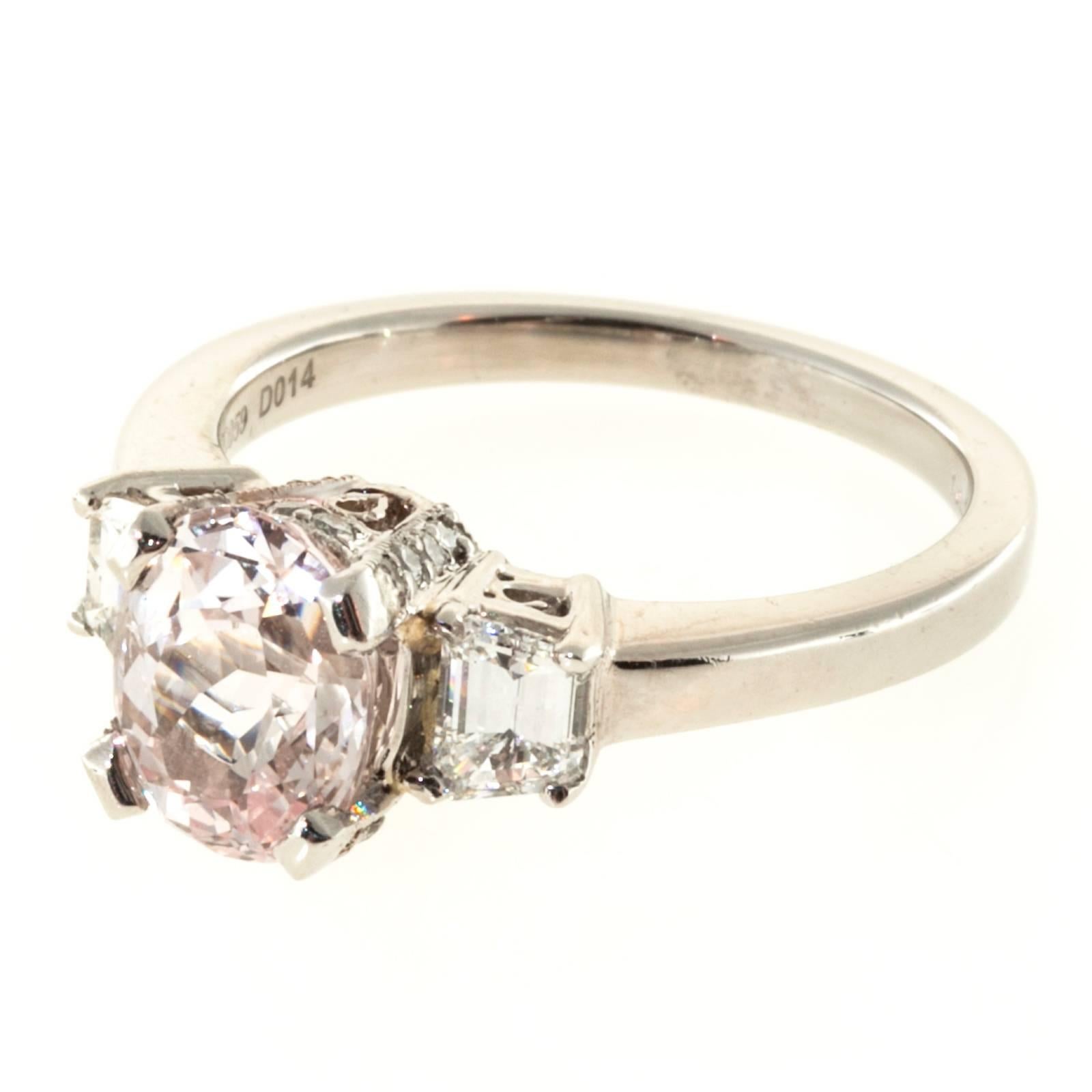 GIA certified natural light peach/orange Sapphire and diamond engagement ring. 2.22 cts center sapphire in a platinum three-stone setting with accent diamonds along the crown.  

1 Light peach / orange oval Sapphire, approx. total weight 2.22cts,