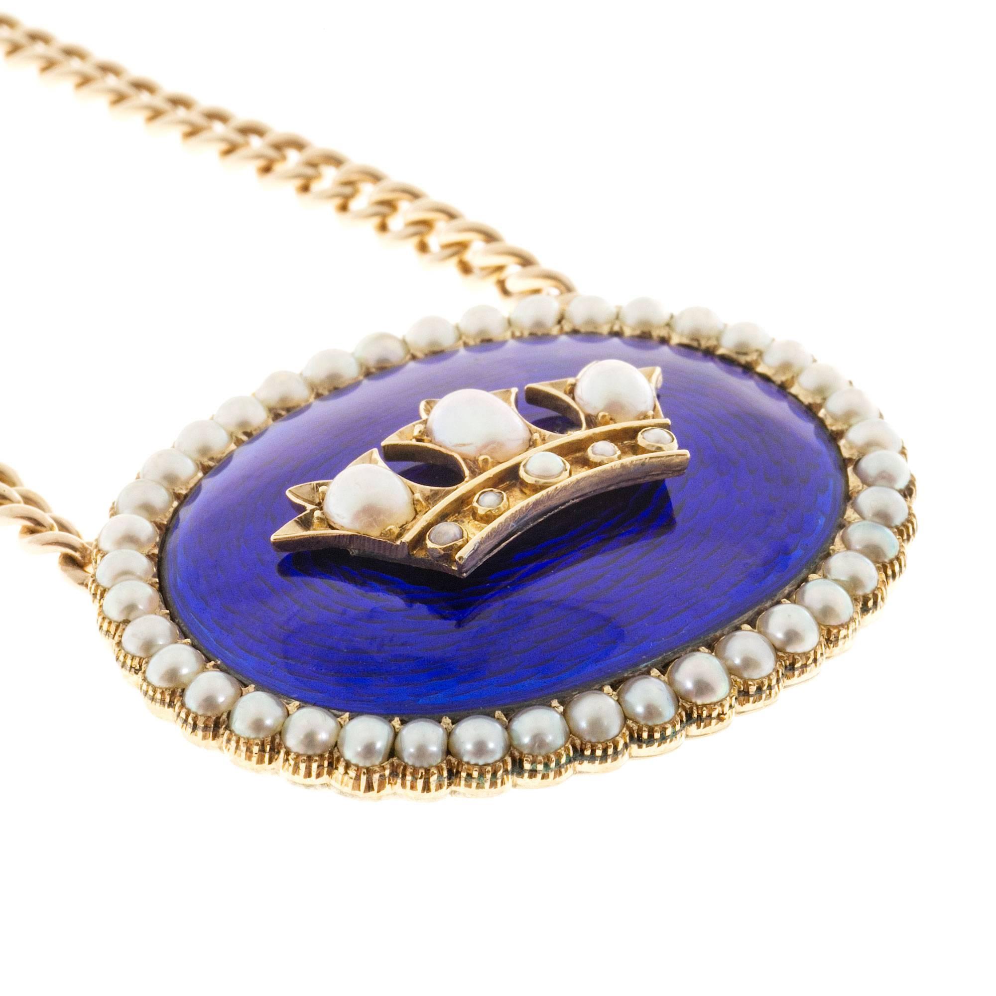 Victorian 18k yellow gold vivid cobalt blue enamel center pendant with natural pearl halo and crown center. Hand made in 14k yellow gold with a spring ring catch. Circa 1900's. Length 17 inches

39 natural half pearls, 3mm, white with silvery