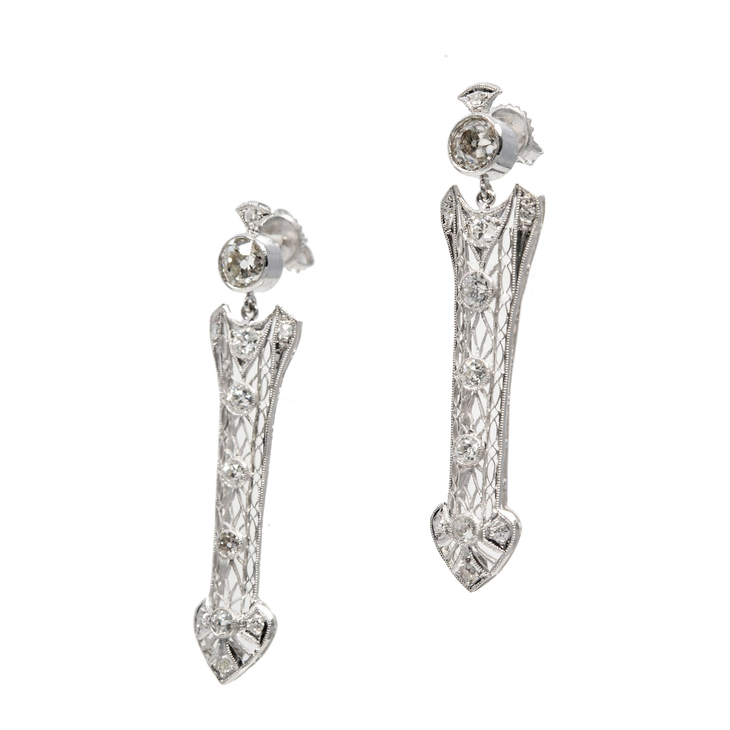 Edwardian 1910 arrow design dangle diamond earrings. Original vintage design with Old European cut diamonds with raised crowns and small tables in arrow shaped platinum settings. 

Tops: 2 old European cut diamonds, approx. total weight 1.42cts, H –