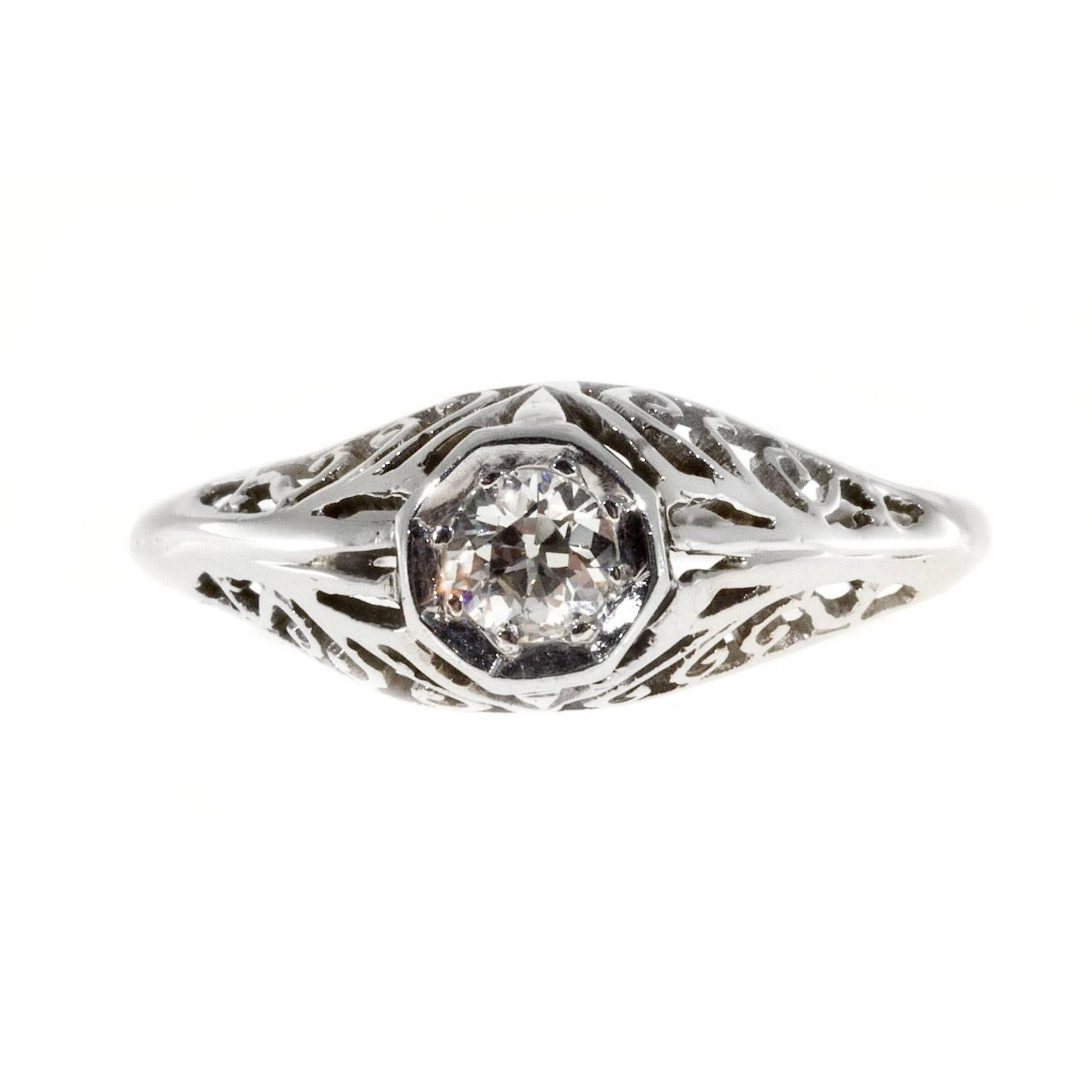 Late 1940 pierced filigree white gold engagement ring with European cut diamond original late Art Deco.

One round European brilliant cut diamond, approx. total weight .25cts, H-I, SI1
14k White Gold
Tested: 14k white gold
2.4 grams
Width at top: