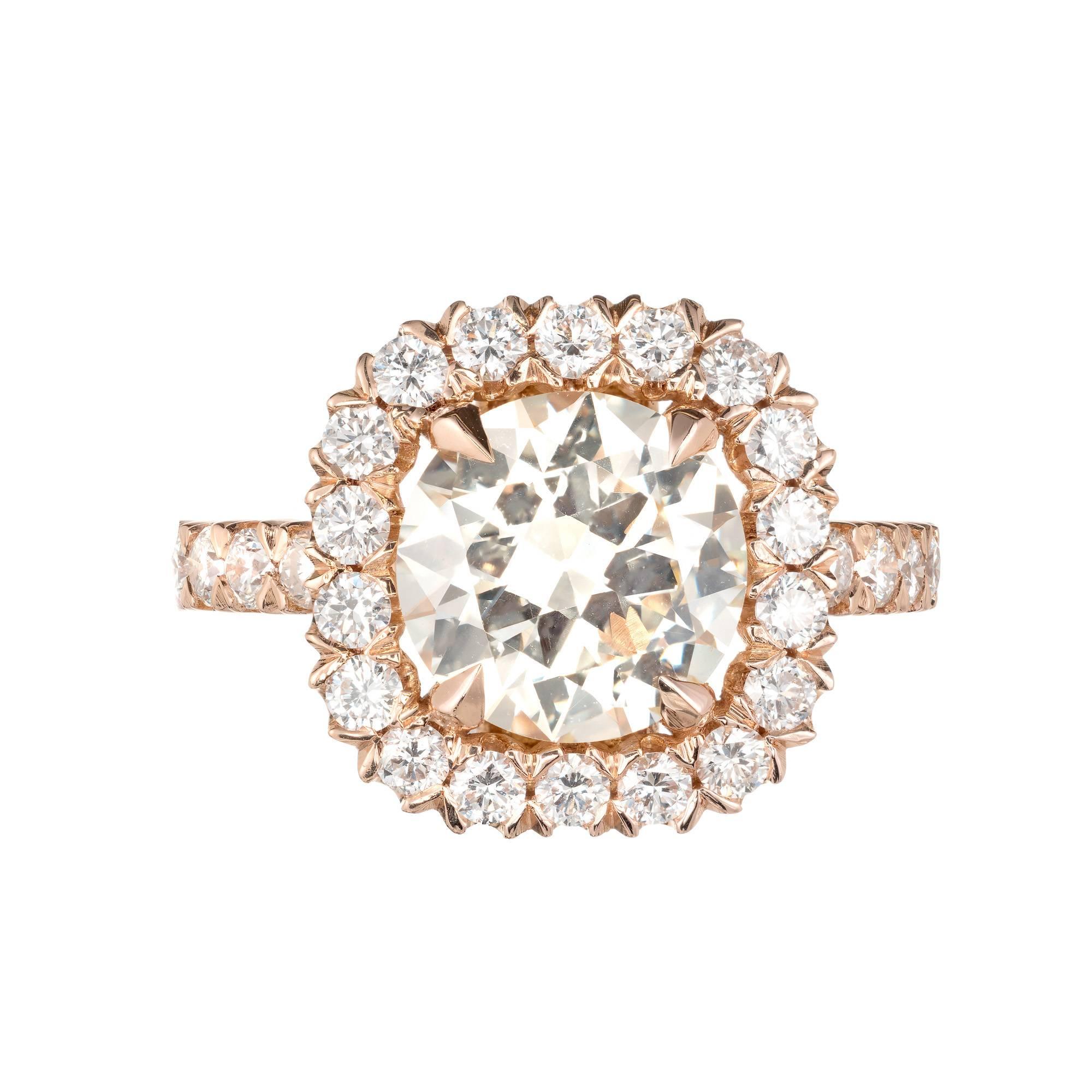 2.43ct transitional ideal cut diamond halo engagement ring. GIA certified center stone with a halo of full cut round diamonds in a 18k rose gold setting with accent diamonds along the shank. The center diamond has wonderful brilliance with a warm
