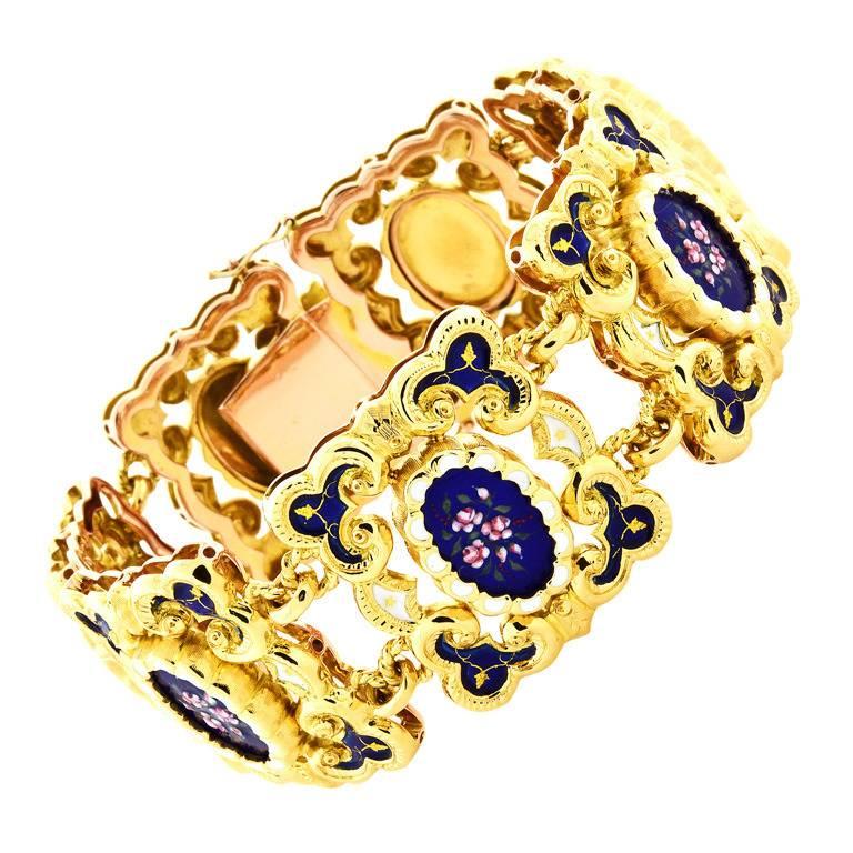Fine rich yellow solid 18k yellow gold 7 section hinged link bracelet. Bright and shiny blue and white floral enamel inlays with intricate. 

Width: 26.67mm or 1.05 inches
Depth: 5.39mm
90.8 grams
Tested: 18k
Stamped: 750
Length: 7.5