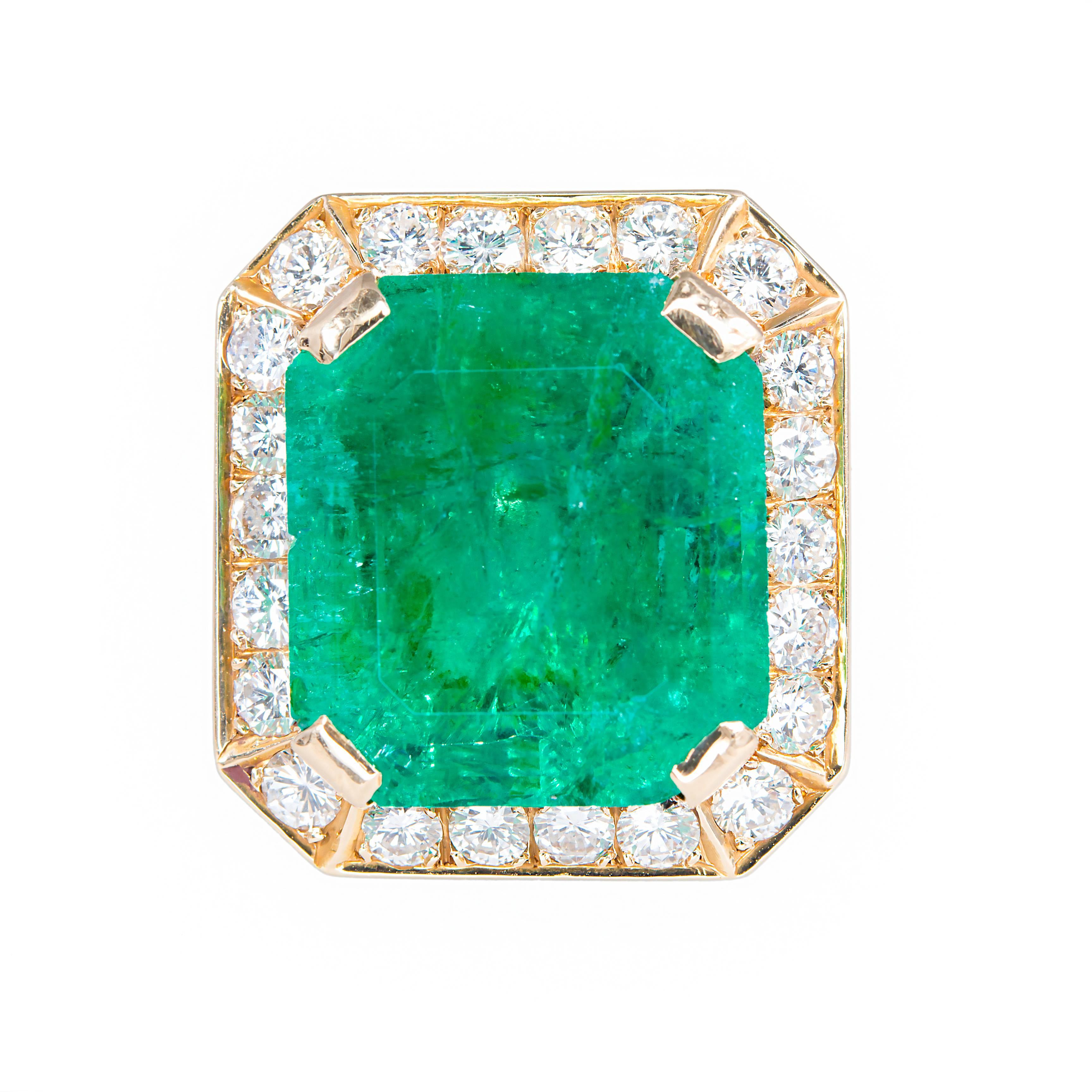Handmade 14k yellow gold eight sided emerald ring. GIA certified 18.75ct emerald center stone with a halo of 22 round diamonds in a 14k yellow gold setting. Mid-century, 1960's. 
 
1 square step cut Colombian Emerald approx. total weight 18.75cts.