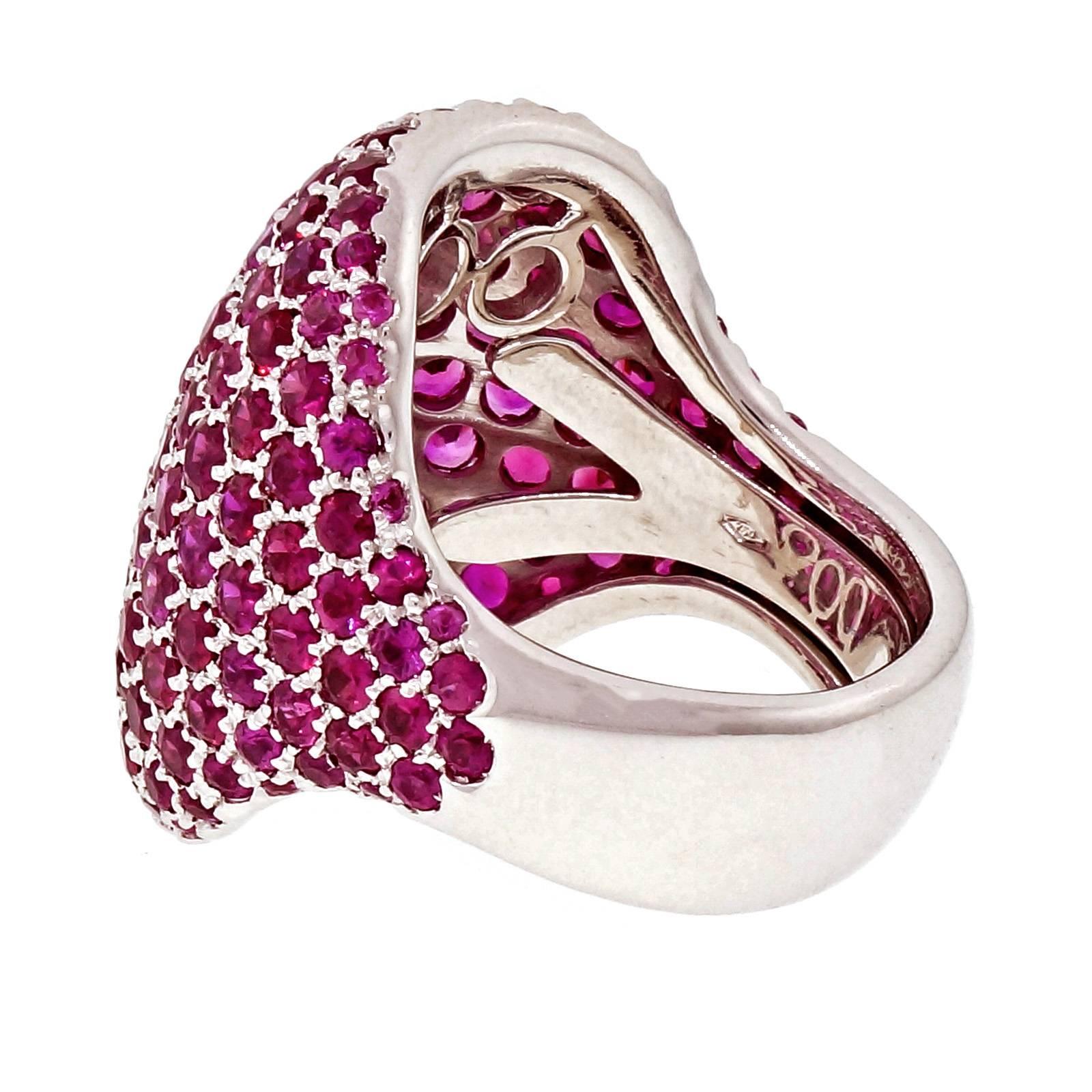 Dramatic Pavé set 19.50ct pink Sapphire dome ring.

160 round pink Sapphires, approx. total weight 19.50cts
18k white gold
Tested: 18k
Stamped: 750
21.2 grams
Width at top: 26.01mm
Height at top: 6.54mm
Width at Bottom: 8.49mm
Size 9.5