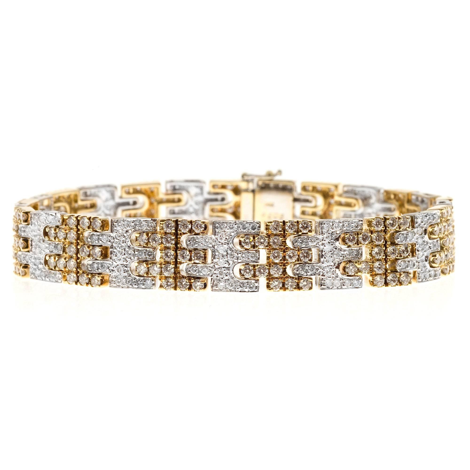 Authentic Sonia B alternating yellow and white gold link bracelet with 394 bright full cut diamonds totaling 6.06cts total. 

394 round full cut brilliant diamonds, approx. total weight 6.06cts, G, VS

29.6 grams
Tested: 14k
Stamped: 14k