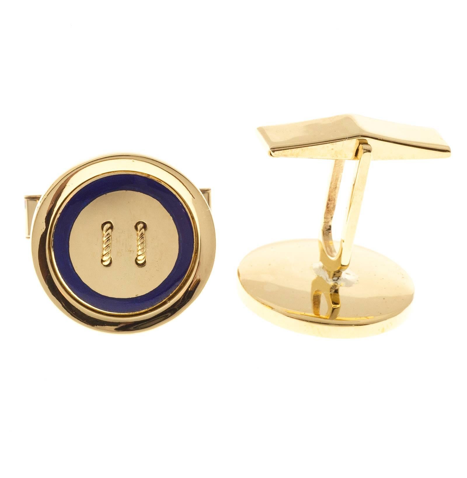 Round button style solid 18k yellow gold cuff links with a blue enamel rim. Circa 1960.

18k yellow gold
Tested and stamped:  18k
19.9 grams
Top to bottom: 21.12mm or .83 inch
Width:  18.61mm or .73 inch
Depth: 3.40mm
