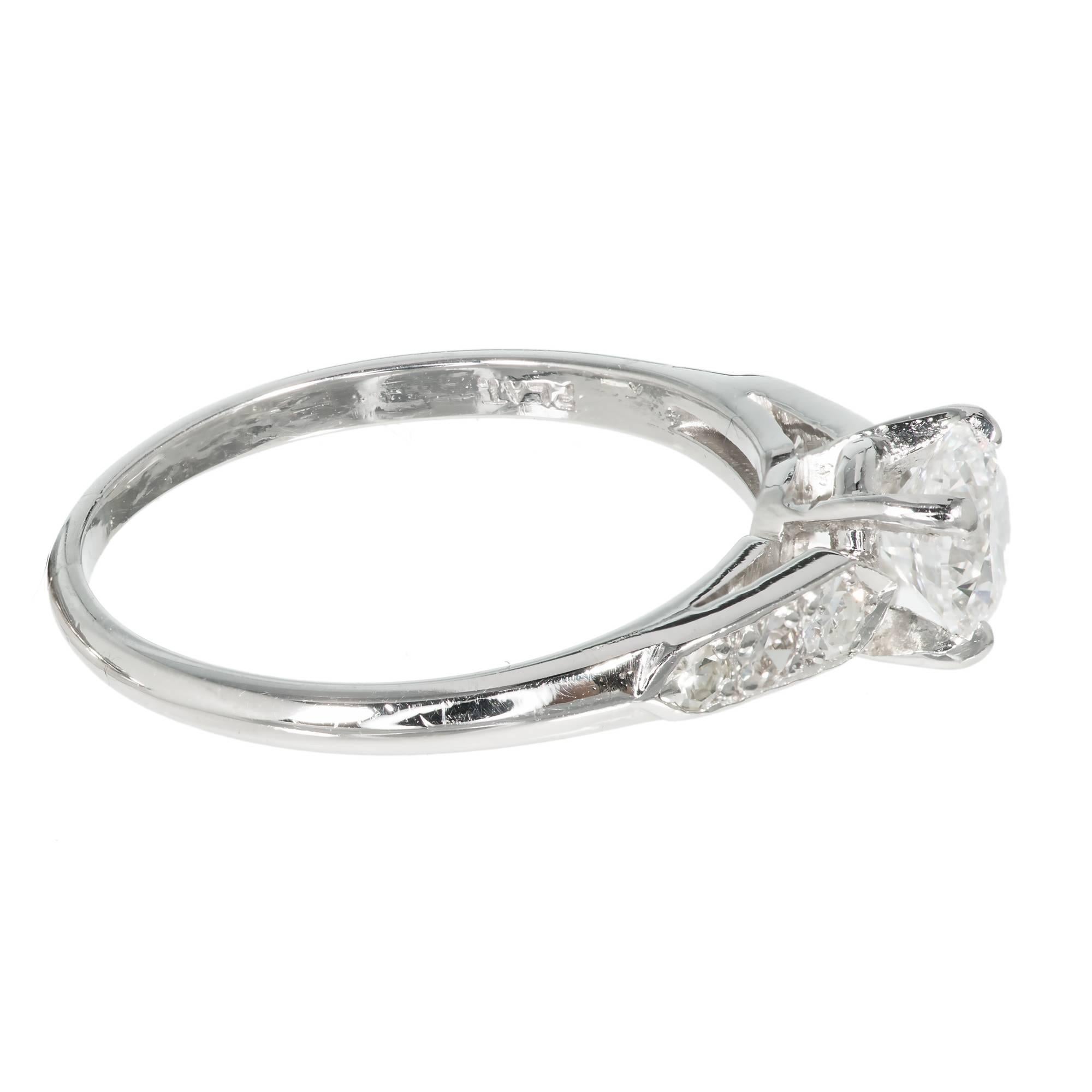 Circa 1930s late Art Deco diamond platinum engagement ring. Platinum setting with side diamonds

1 round transitional cut diamond, approx. total weight .65cts, E to F, VS1, 5.38 x 5.36 x 3.22mm, Depth: 59.9% Table: 58% EGL certificate