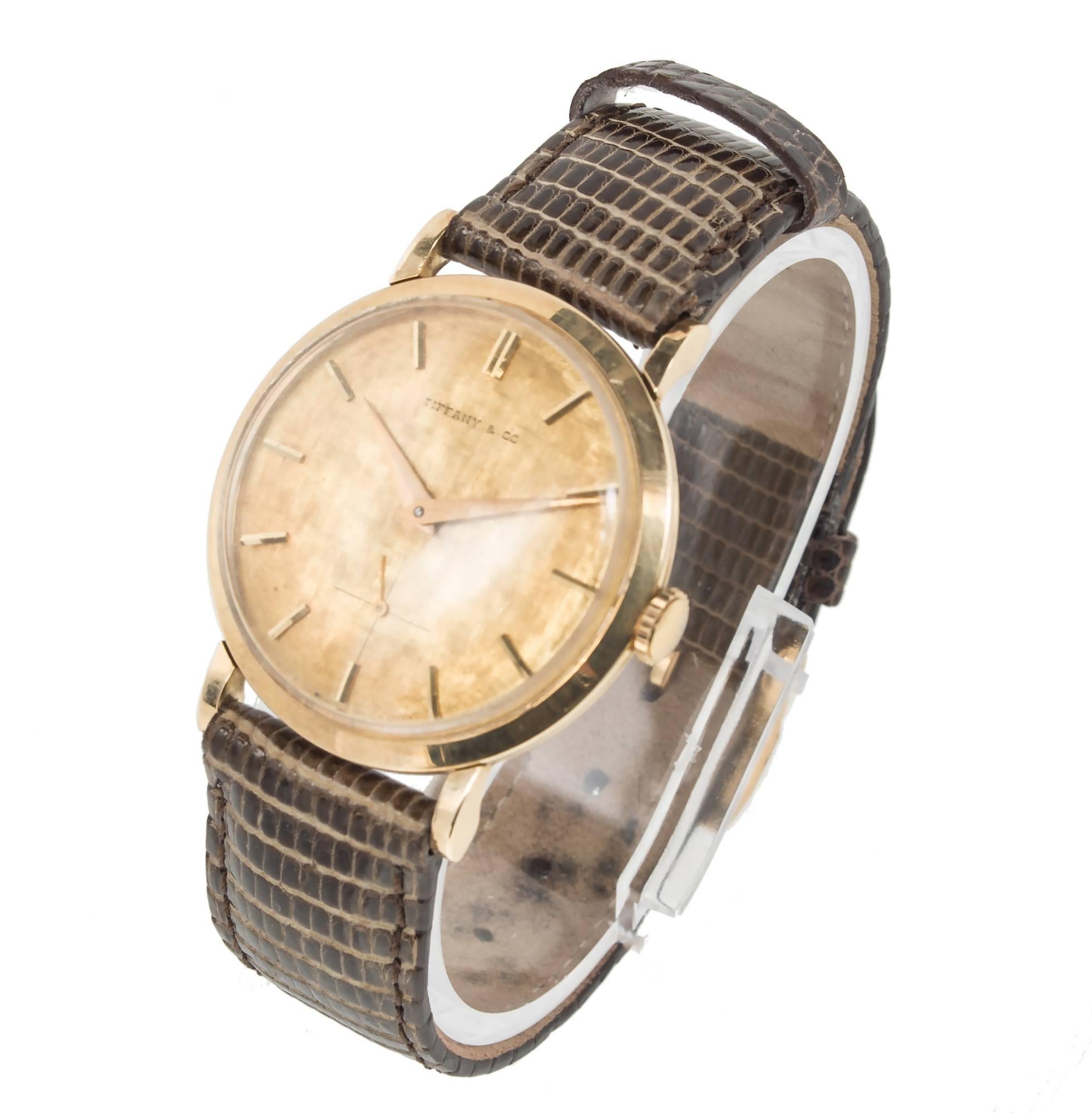 Tiffany & Co. Movado men's wristwatch is a timeless piece, crafted with 14k yellow gold, this wristwatch retailed by the renowned Tiffany & Co. brand effortlessly blends classic style with modern design. Florentine gilt dial with natural patina,