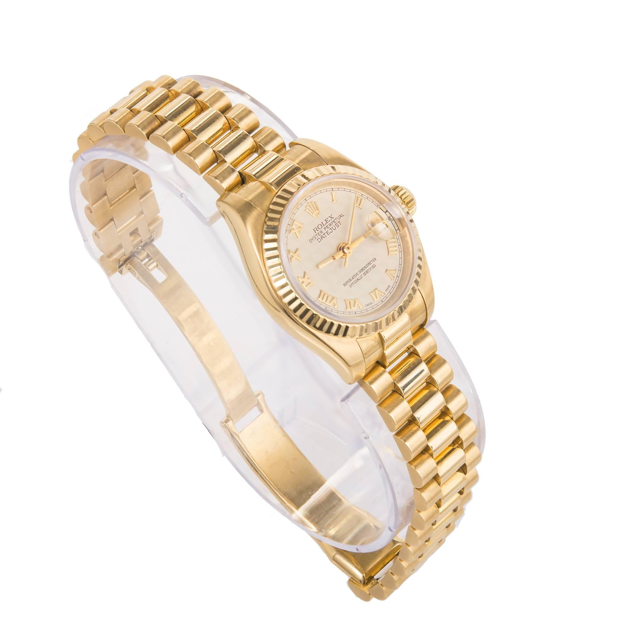 Rolex lady's 18k yellow gold Datejust wristwatch, Ref. 179178, circa 2002, cream-colored textured dial with gold Roman numerals. The dial has a pattern on it that is hard to photograph. the close up photo captures it accurately. 

18k yellow gold