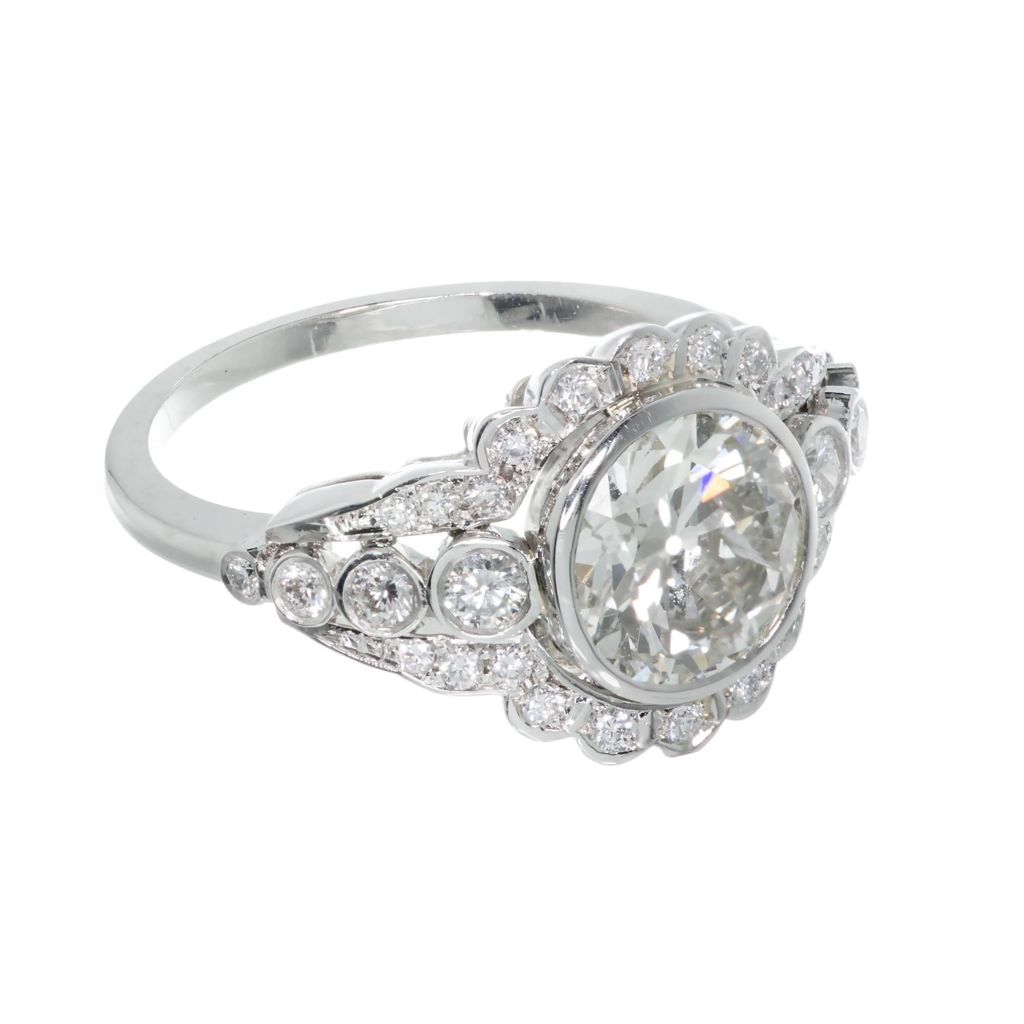 1930-1939 European cut 2.05ct original bezel set diamond halo engagement ring. 2.05 Old European cut center stone set in platinum with 30 round  diamond accents.

1 round old euro diamond, approx. total weight 2.05cts, K – L, I1, 
30 round diamonds,
