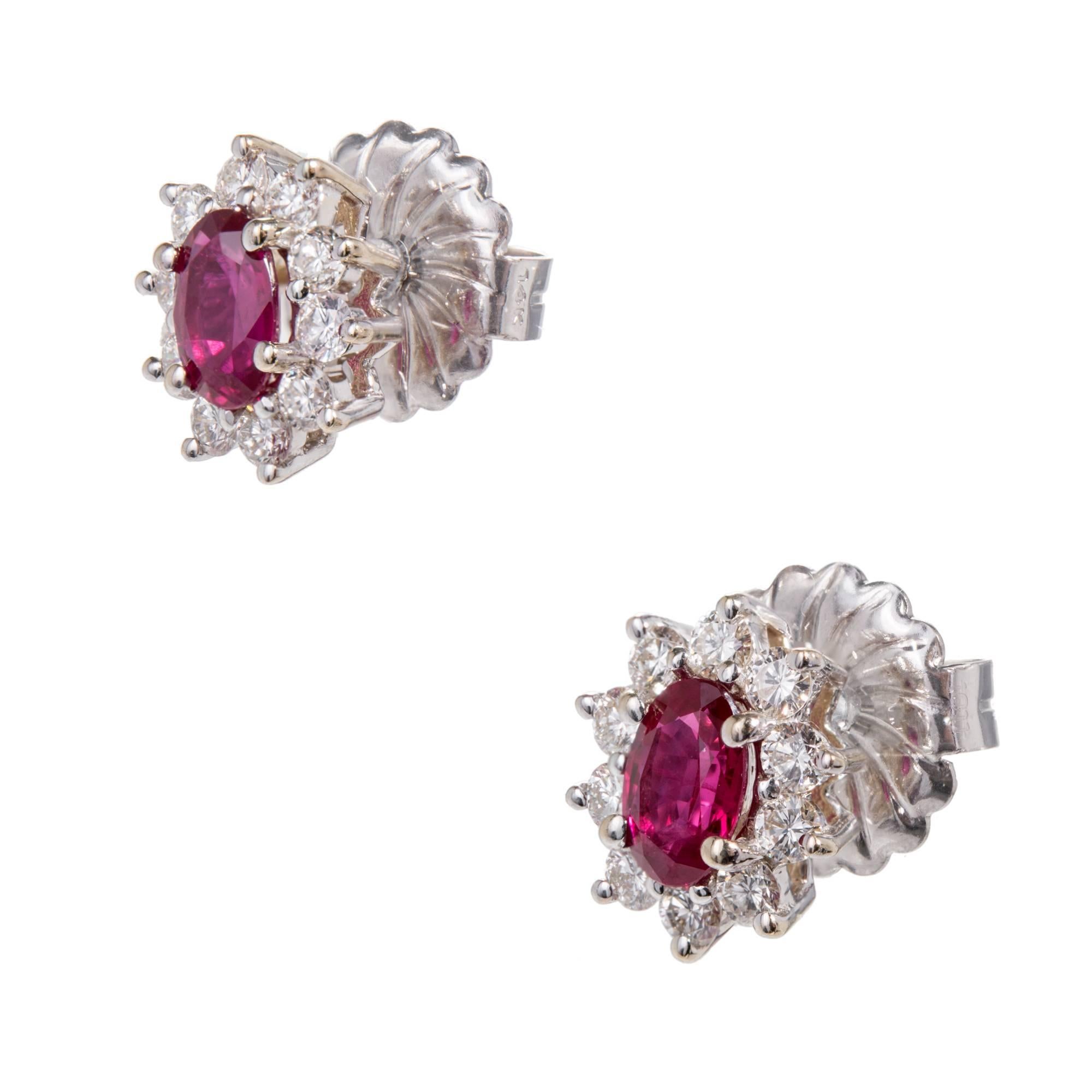 Oval ruby and diamond halo 14k and 18k white gold earrings. Heat with minor residue in fissures. Natural corundum. GIA certified. Backs tested and stamped 14k, circa 1970-1980. Earrings tested and posts stamped 750-18k. GIA certified in the