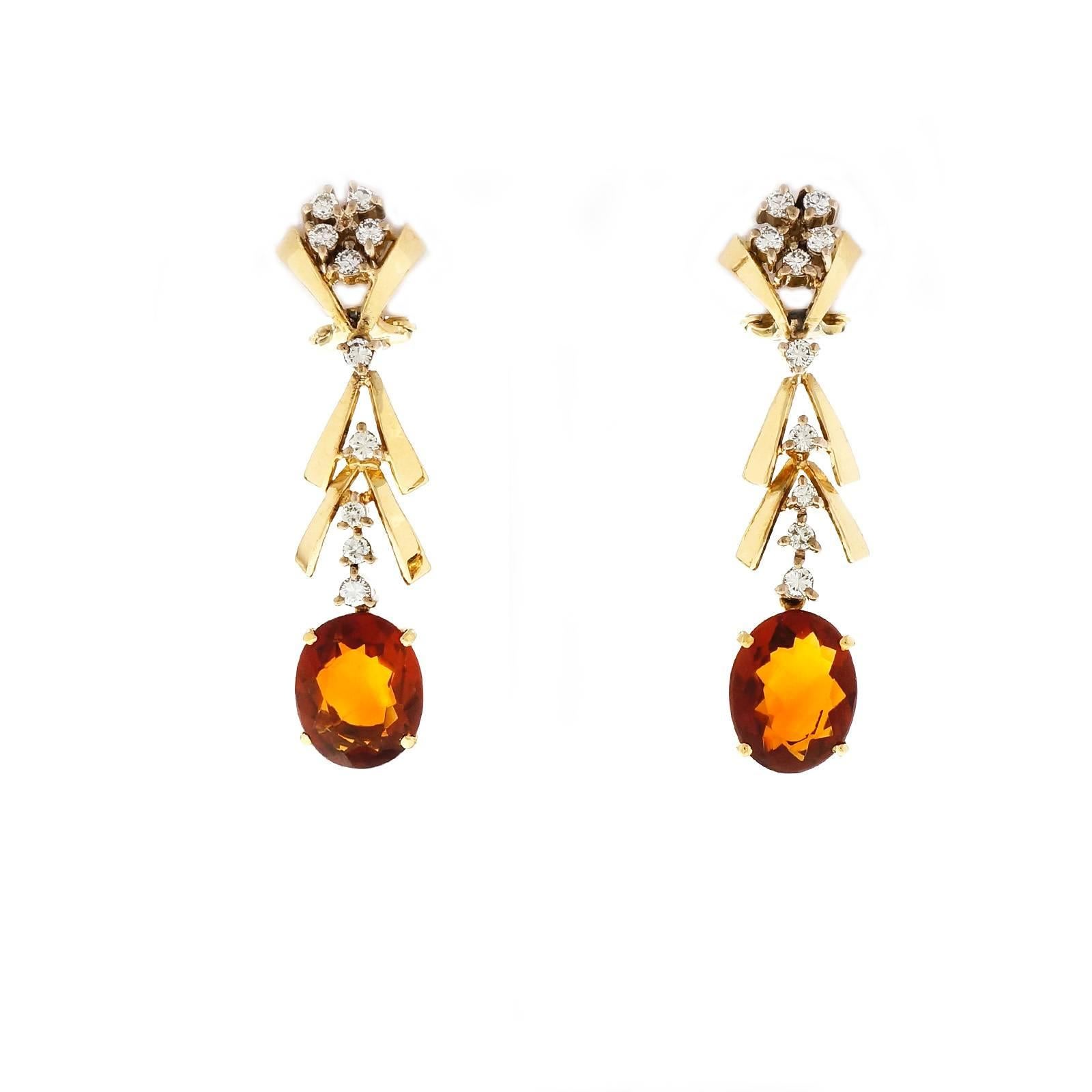 Wonderful 1950 to 1960 vintage 18k white gold and yellow gold dangle earrings with bright sparkly diamonds and fine orange Citrines.

2 oval Madera orange Citrine, 10.73 x 8.88 x 3.97mm
20 round full cut diamonds, approx. total weight .60cts, G –