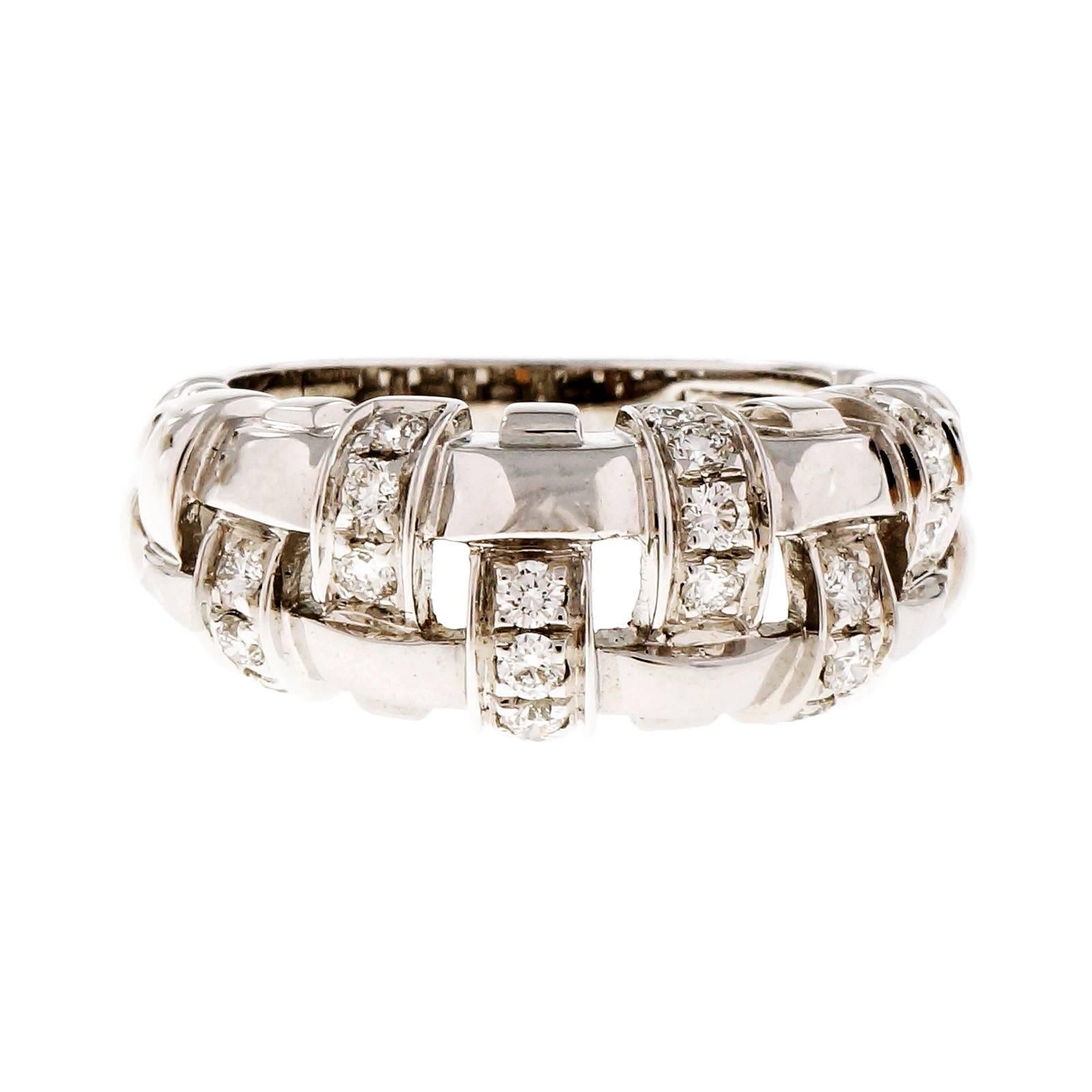 Tiffany & Co. basket weave 18k white gold diamond ring.

19 round diamonds, approx. total weight .50cts, F, VS
18k white gold
Tested: 18k
Stamped: 750
Hallmark: T & Co ©2002 Italy
l6.2 grams
Width at top: 8.34mm
Height at top: 5.03mm
Width