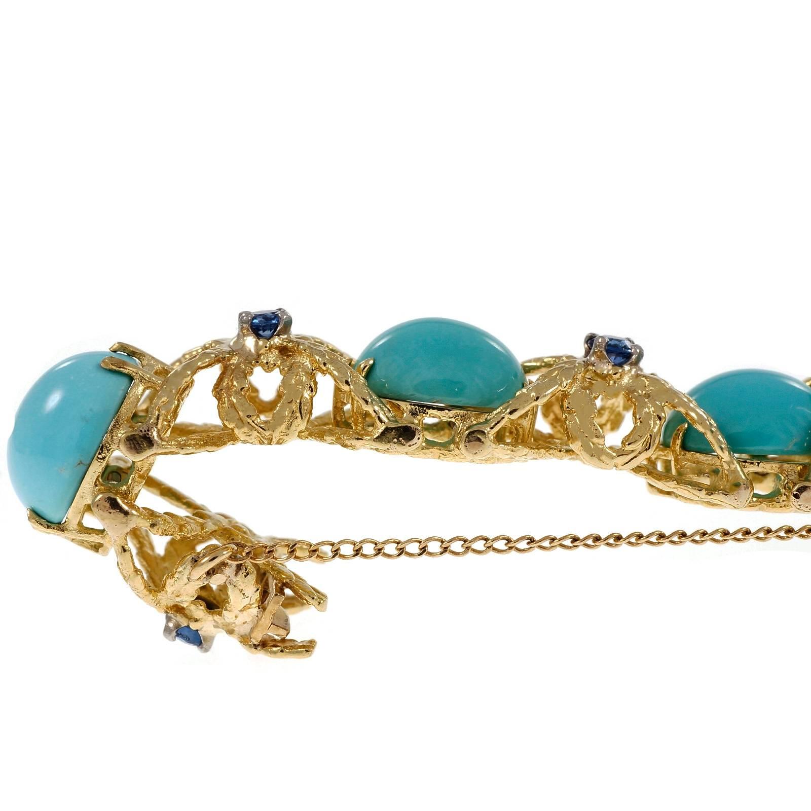 Handmade highly detailed 18k yellow gold bracelet circa 1950 with bright natural untreated Persian Turquoise and fine vivid blue natural Sapphires. Built in clasp and safety chain.

10 oval cabochon blue Turquoise, opaque, 9.70 x 7.96 x 4.12mm,