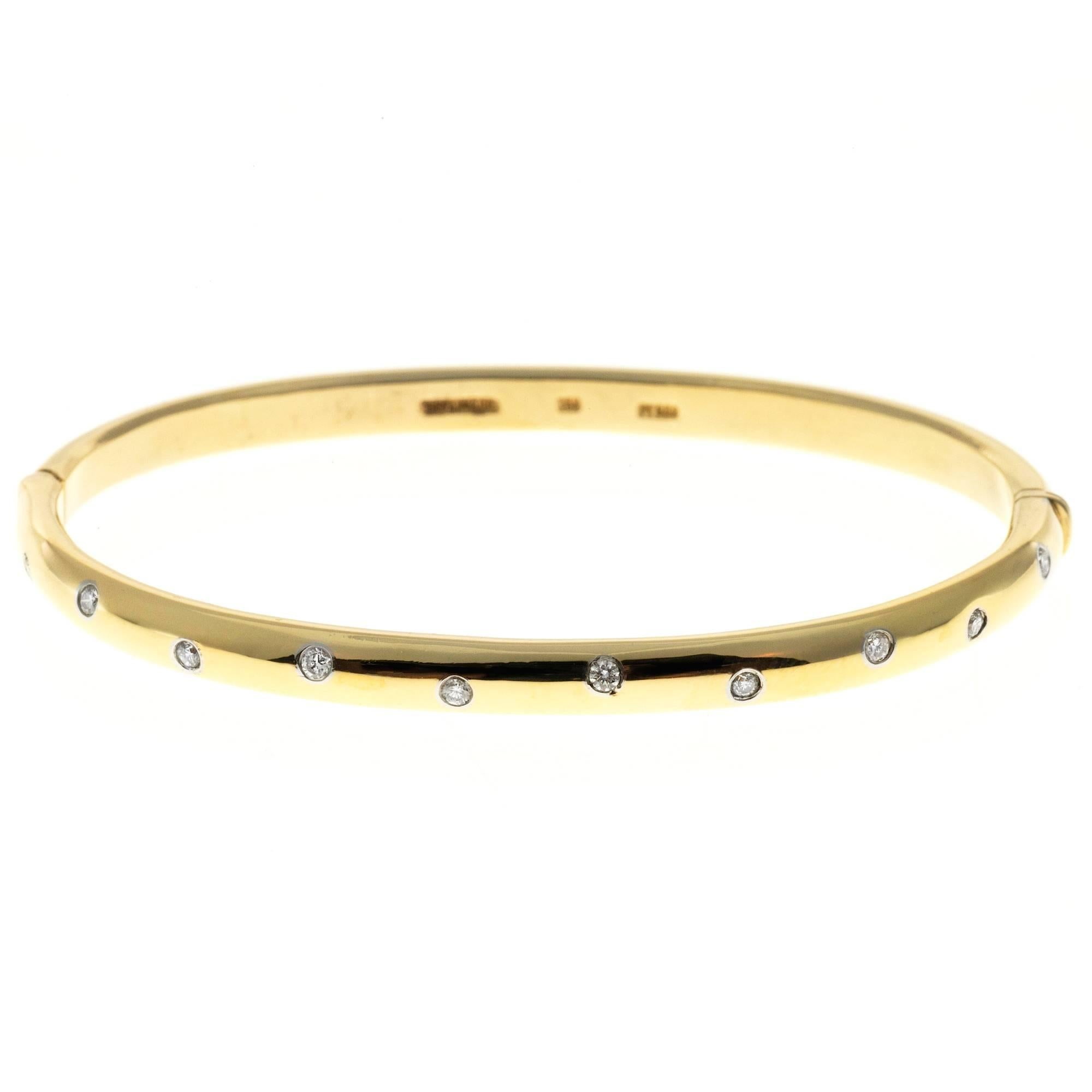 Tiffany & Co Etoile solid 18k yellow gold bangle bracelet with full cut diamonds in Platinum tubes.

18k Yellow gold & Platinum
10 round brilliant cut diamonds, approx. total weight .30cts, F-G, VS
Width: 4.6mm
Depth: 3.2mm 26.9 grams
Tested: