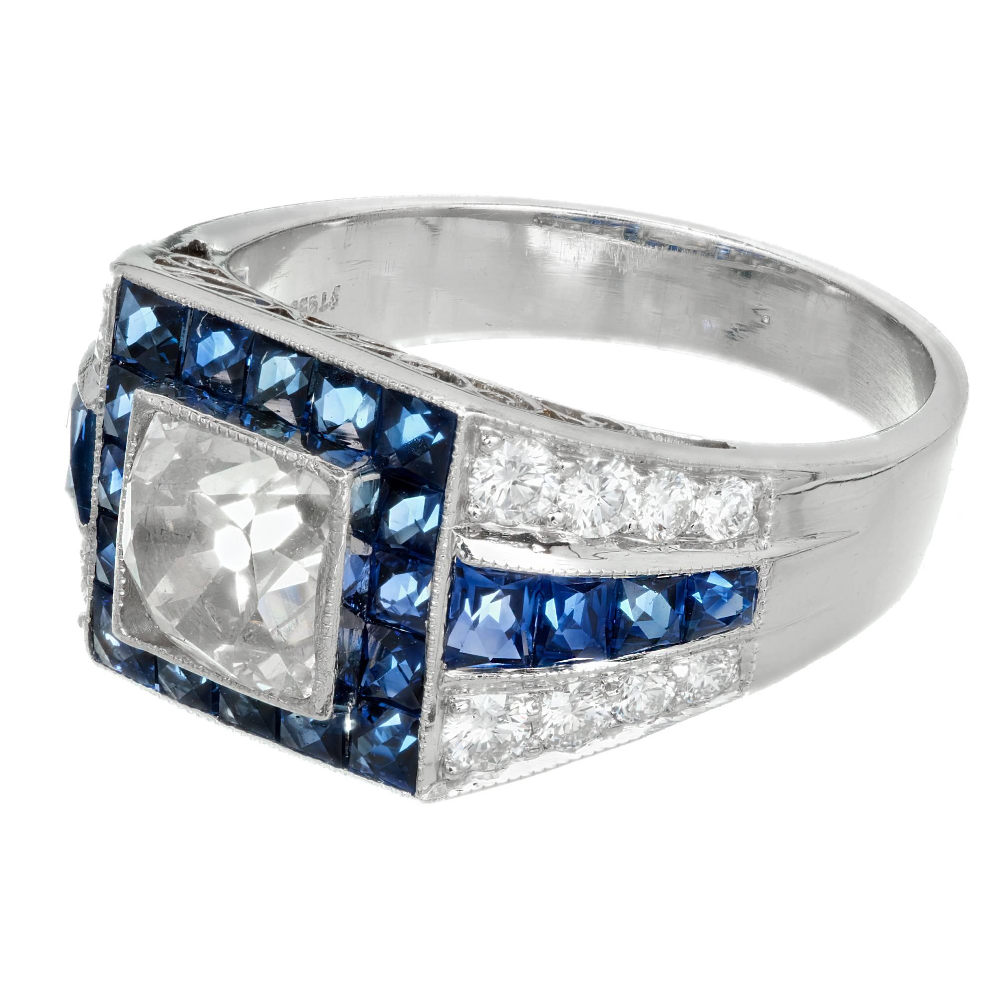 Art Deco diamond and sapphire engagement ring. EGL certified 1.48ct antique cushion French cut  center diamond with a halo of blue Sapphires with French calibre cut tops in a platinum setting with sapphire and round accent diamonds. 

1 antique