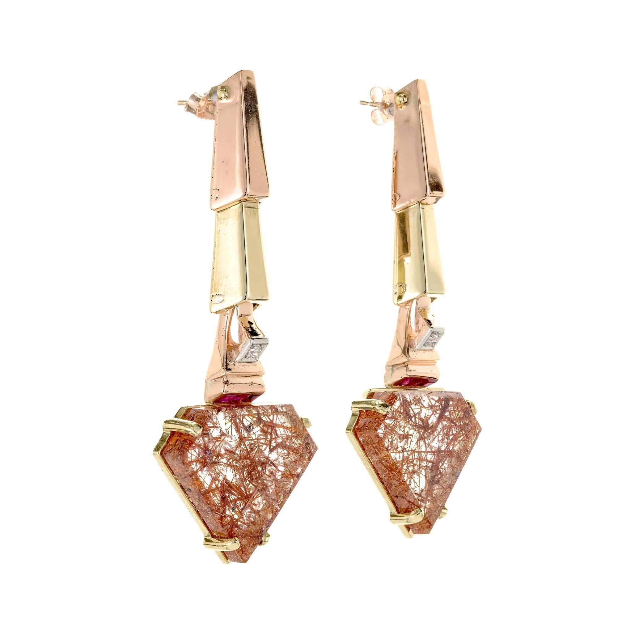 Retro 1935-1940 rose and green gold dangle earrings of angular design with rose gold top links, green gold second links and channel set Rubies and old European cut diamonds. Rutilated Quartz bottoms. A wonderful Retro jewel.

2 flat diamond shape