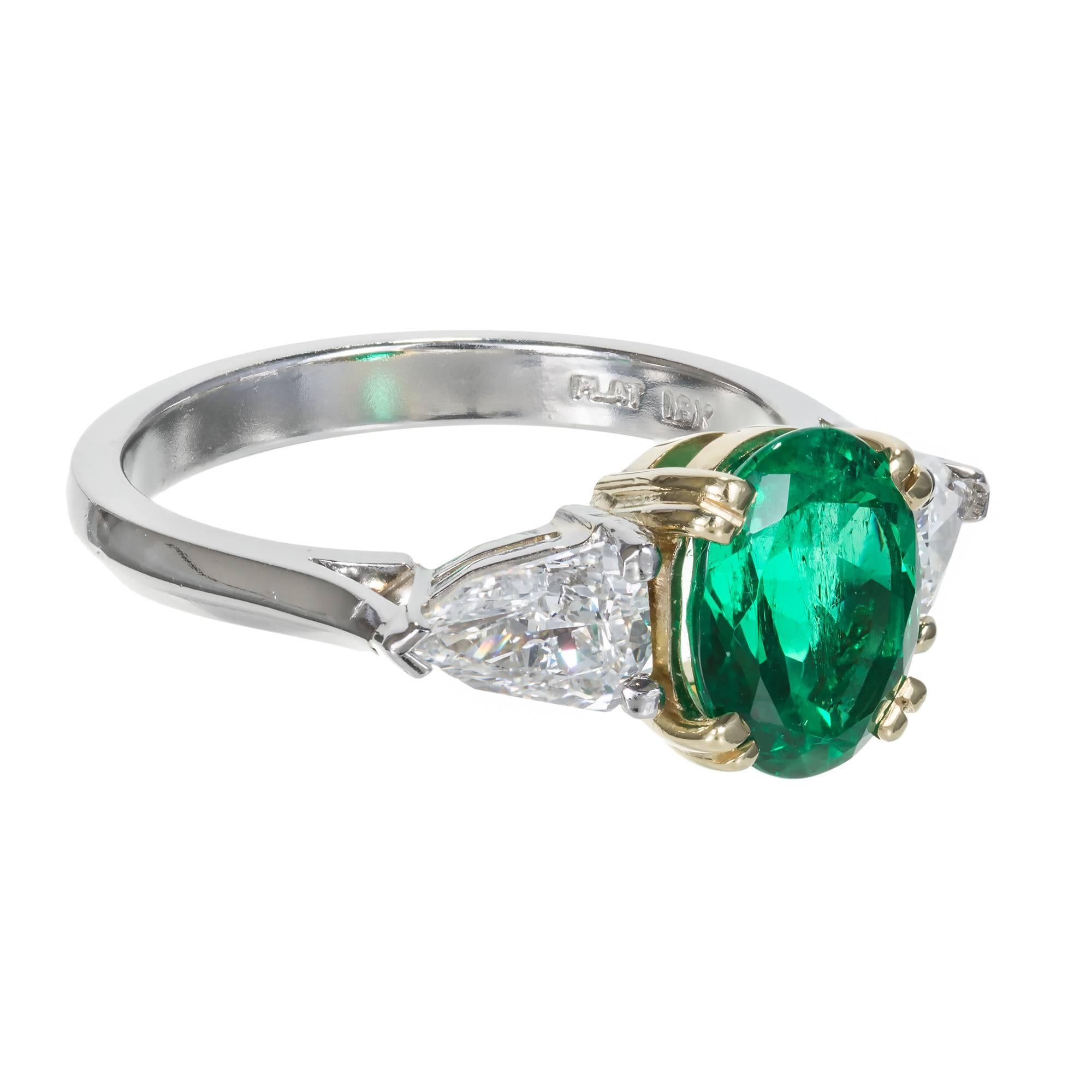 Oval vivid green Emerald diamond three stone engagement ring.  Platinum and 18k yellow gold setting. AGL Certified as natural Emerald minor clarity enhancement only. Certified Colombian origin. The setting was designed in the Peter Suchy