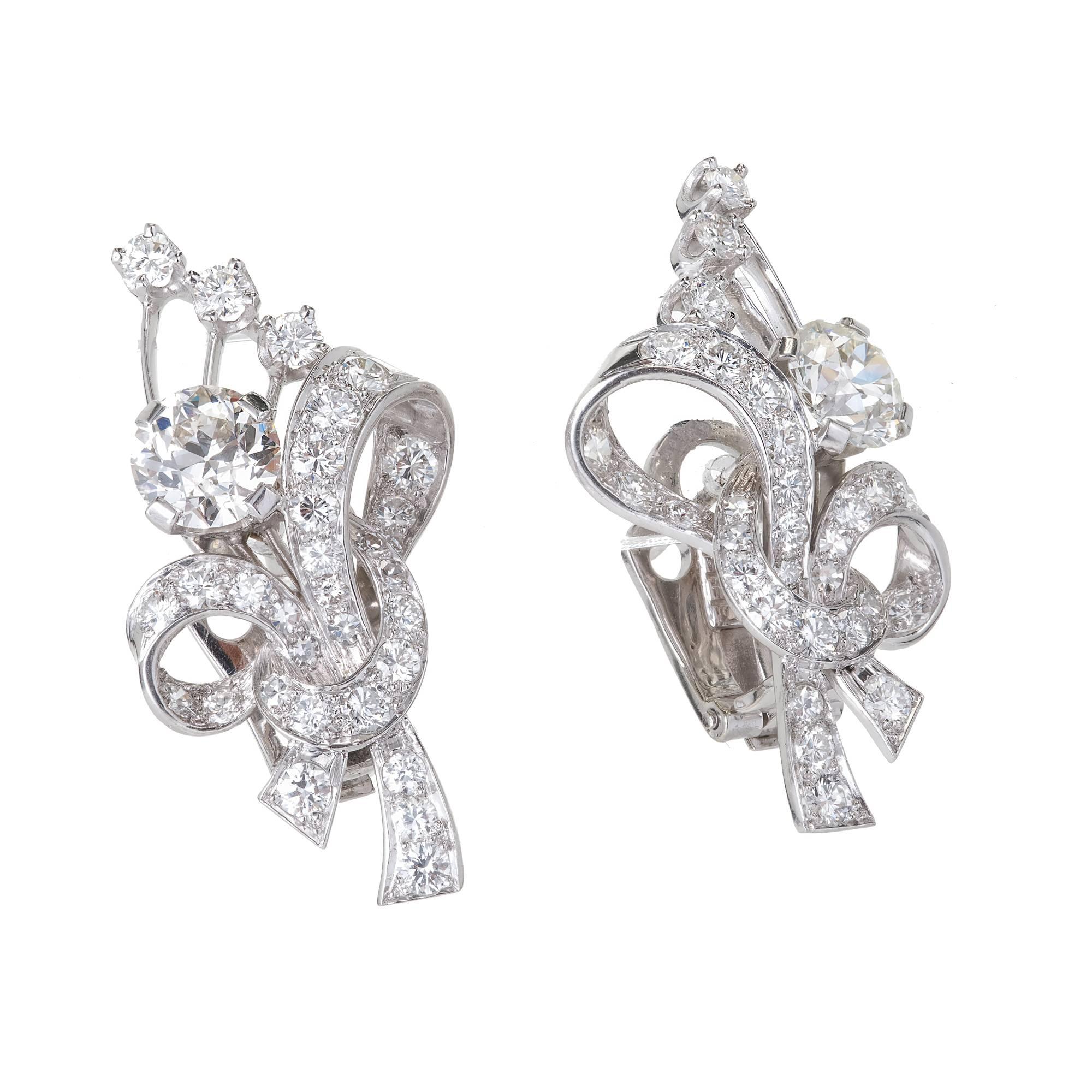 Handmade diamond platinum flower earrings. Circa 1930-1940. The two center diamonds are EGL certified original old European cut diamonds. Ideal cut. Both face up white. 

1 old European cut 1.38ct H, VS1
1 old European cut 1.37ct J, VS1
62 round