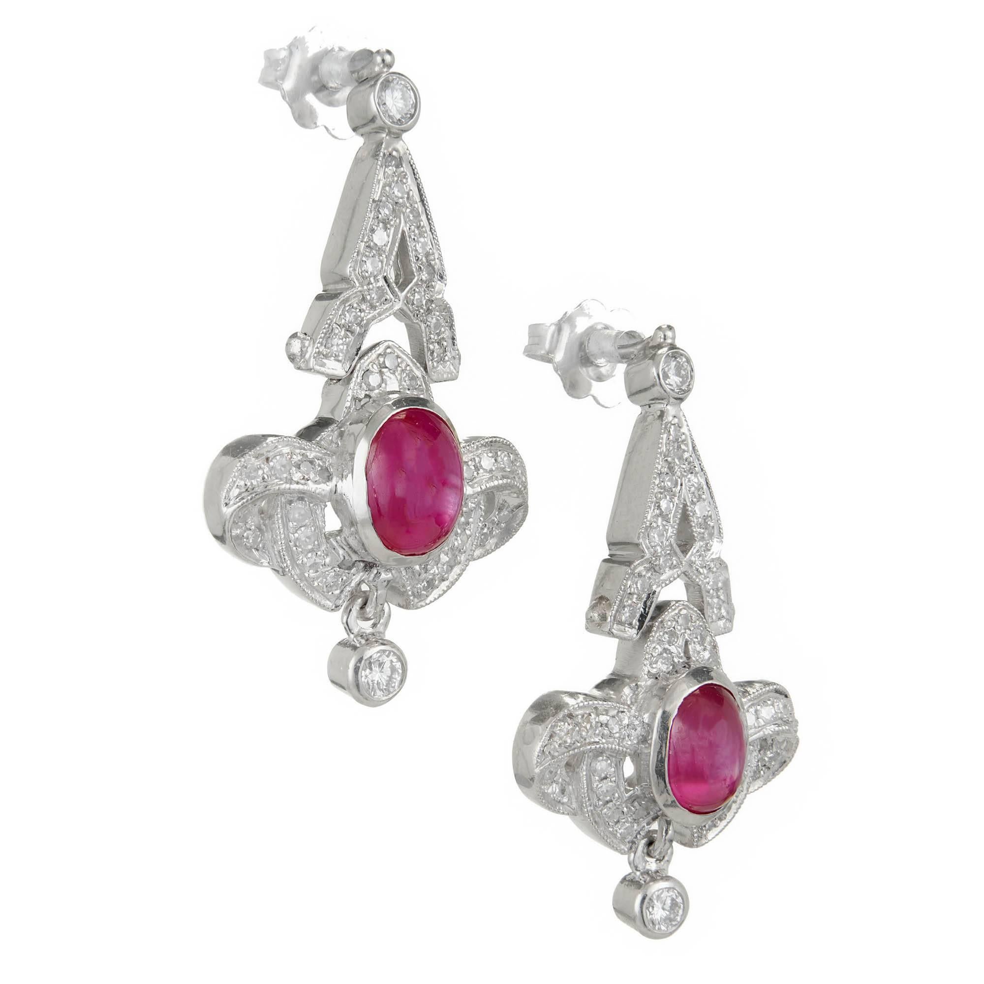 Edwardian handmade platinum ruby and diamond dangle earrings. Each set with pave set diamonds and 2 bright red genuine star rubies. 

2 cabochon oval rubies approx. total weight 1.50cts.
72 round diamonds approx. total weight 1.00cts, H,