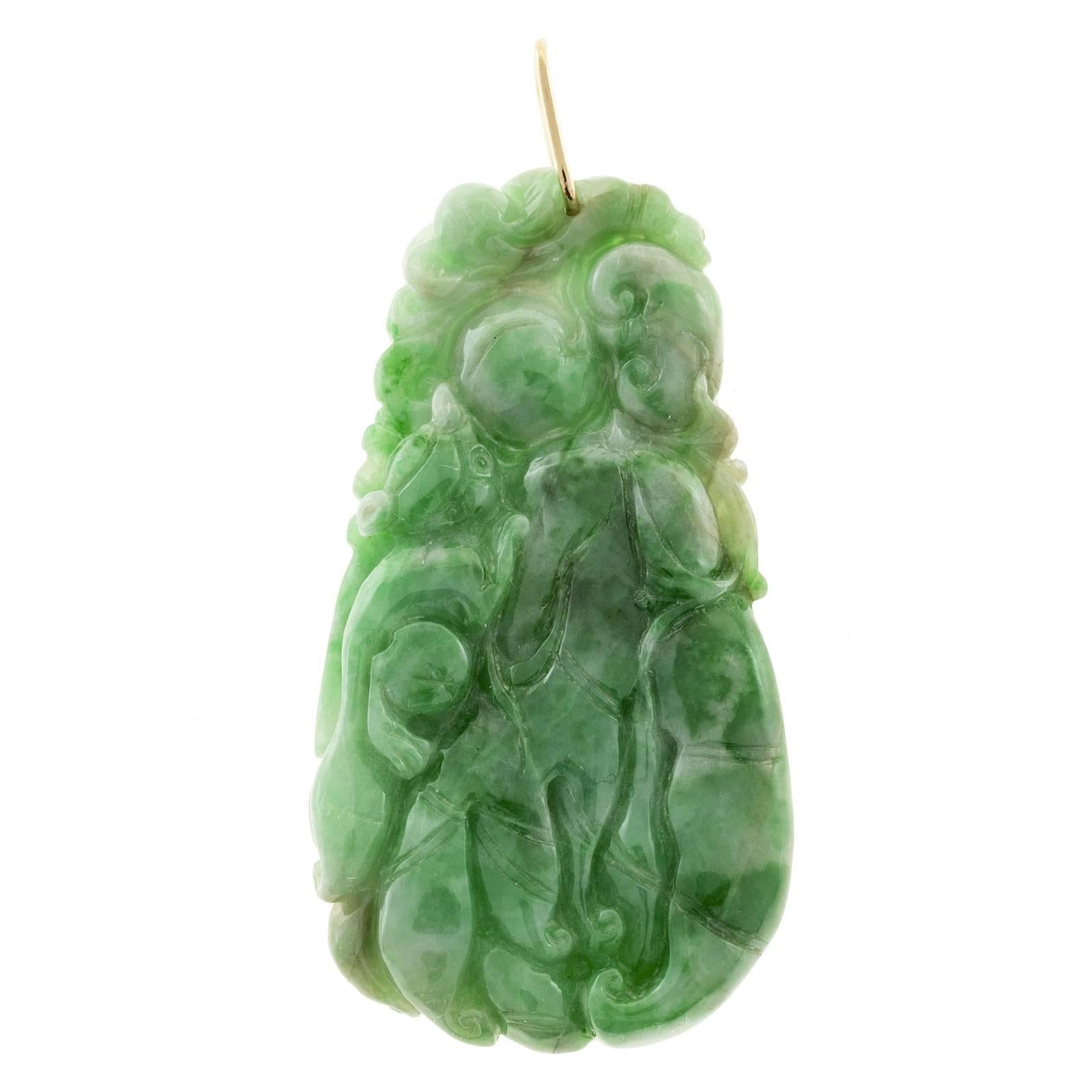 Natural Jadeite Jade carved pendant with a simple 14k yellow gold pendant loop.  Pendant loop tested 14k variegated green color extra fine GIA certified 5141648724. natural Jadeite Jade large double sided carving deeply carved flowing design

59.9 x