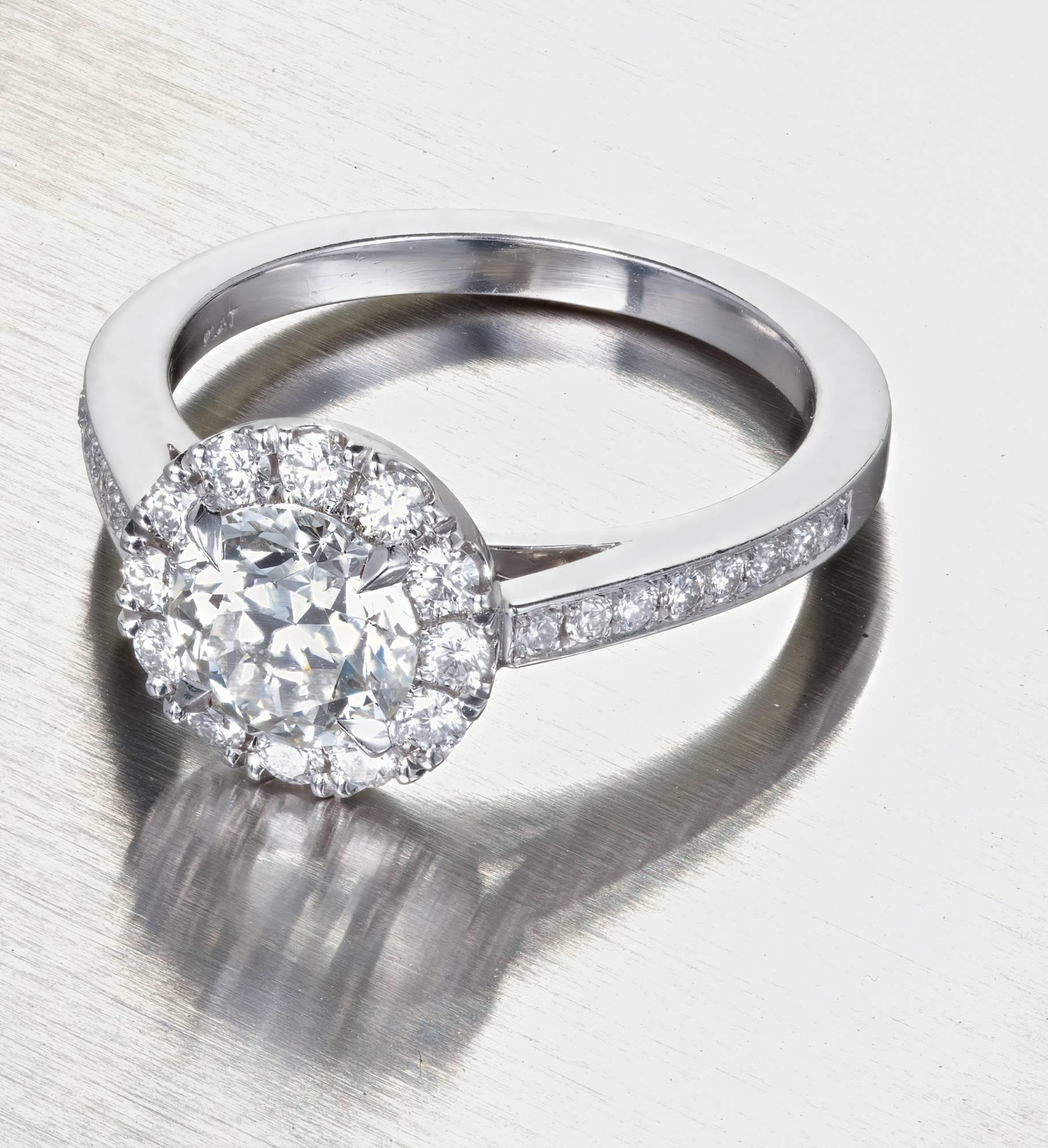 Peter Suchy Ideal cut round white diamond 1.24ct engagement ring. The GIA certified center diamond is accented with a halo of diamonds in a platinum setting with diamonds along the shank.

 Solid Platinum. AUBB.
1 Ideal round brilliant cut diamond,