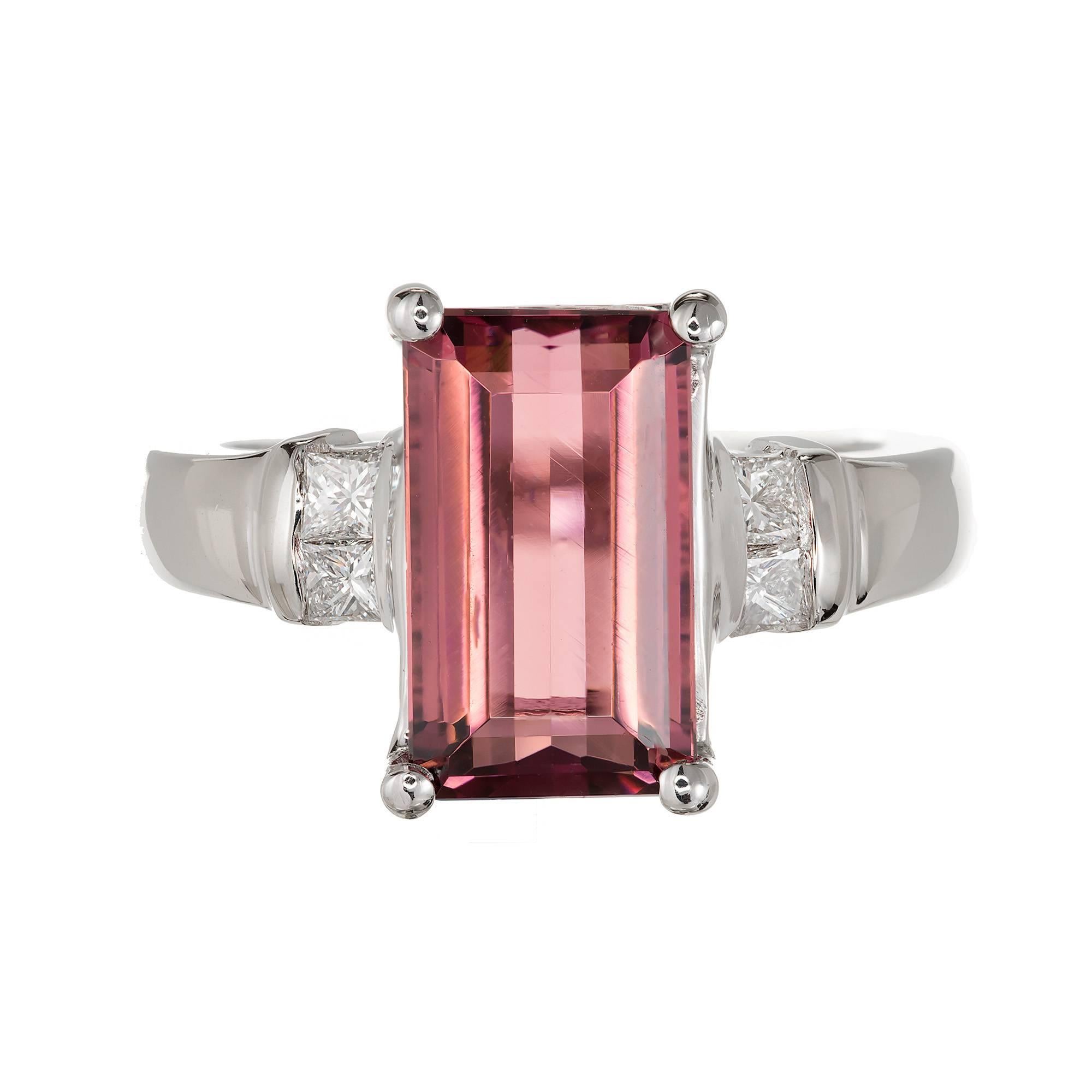 Emerald cut pink Tourmaline and princess cut diamonds in a 14k white gold cocktail ring setting.  

1 Emerald cut natural pink Tourmaline, approx. total weight 3.85cts, VS, 11.8 x 7mm
4 Princess cut diamonds, approx. total weight .25cts, F, VS
Size