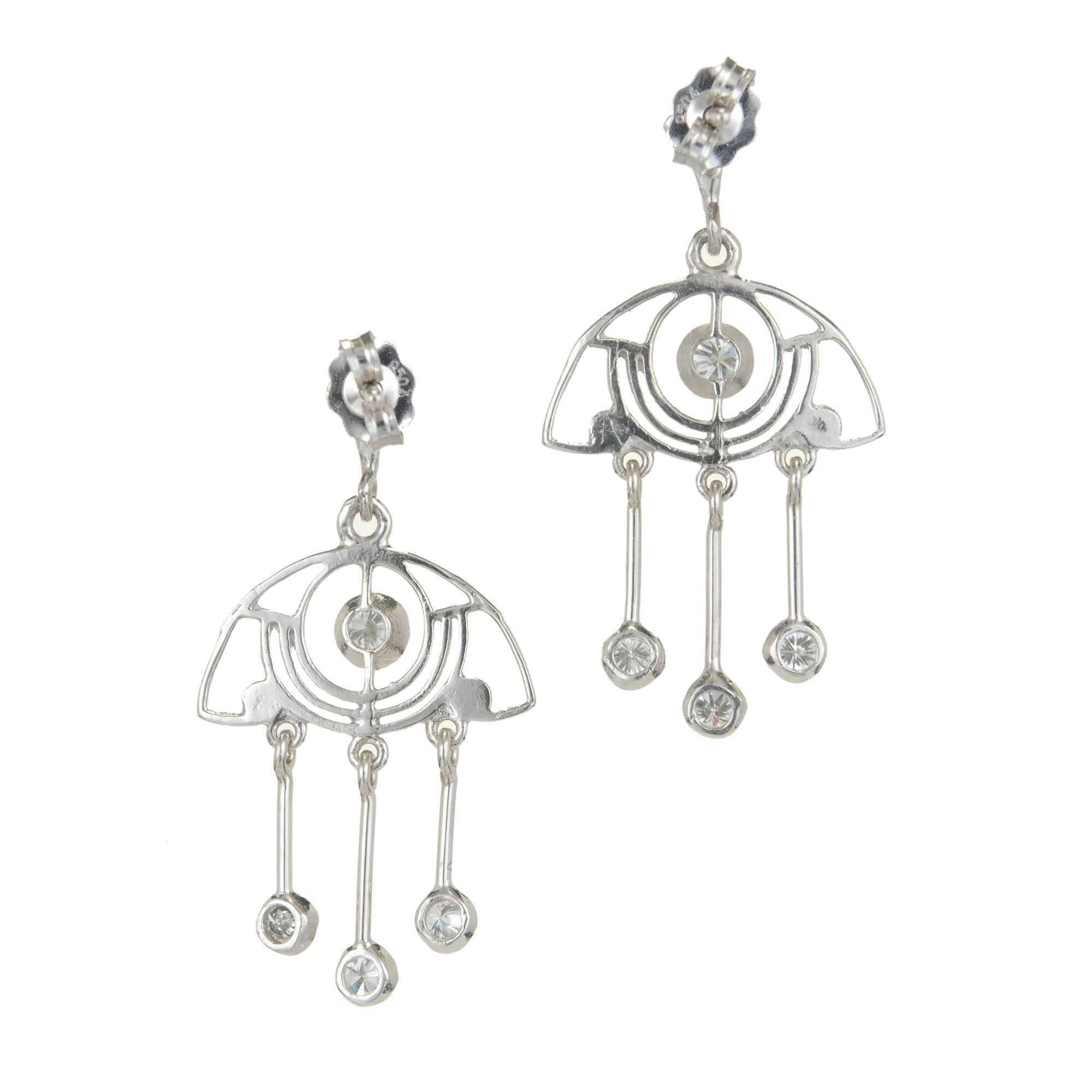 Artistically designed open work diamond dangle chandelier earrings with quality full cut diamonds.

10 brilliant cut diamonds, approx. total weight .64cts, F-G, VS
Platinum
4.1 grams
Tested: Platinum
Stamped: 950 on earrings back
Top to bottom: