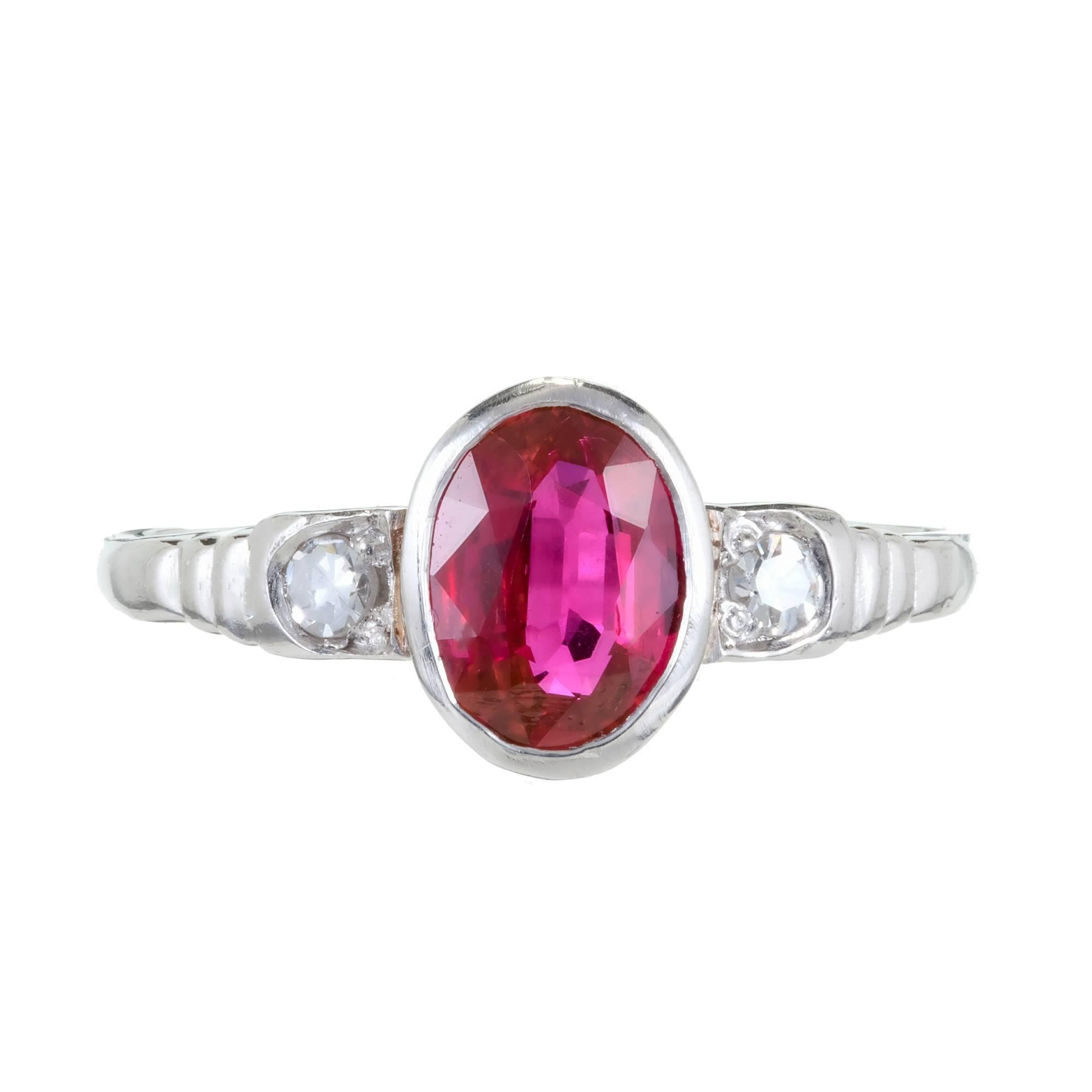 1940 late Art Deco simple Platinum engagement ring with bezel set natural no heat red certified oval Ruby and accent diamonds. AGL Certified GB 47126

1 oval fine red natural Ruby, approx. total weight .80cts, SI1, 7.18 x 5.11 x 2.47mm, no heat and