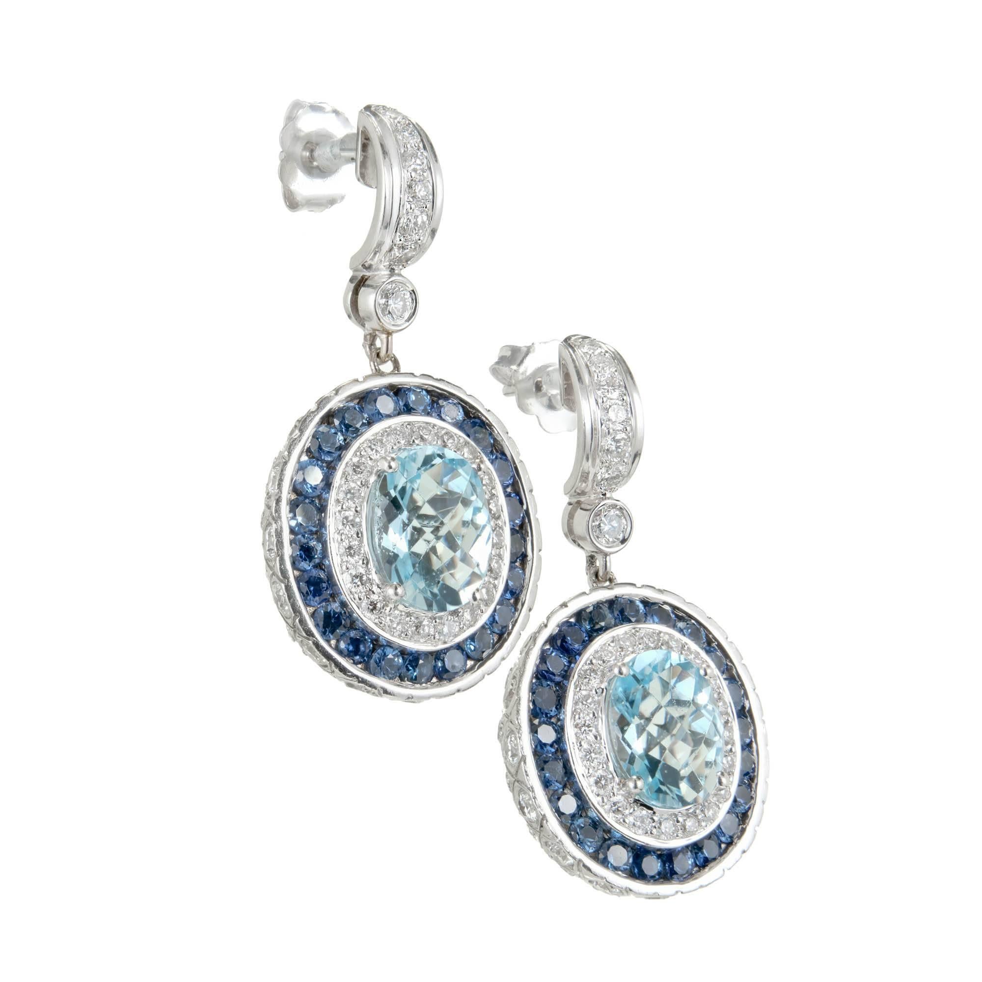 Charles Krypell Aqua, Sapphire and diamond dangle earrings. Oval aquamarine center stones with a double halo of diamonds and sapphires, set in 18k white gold settings.

2 oval Aqua 9 x 7mm, approx. total weight 3.50cts
42 round fine blue Sapphires,