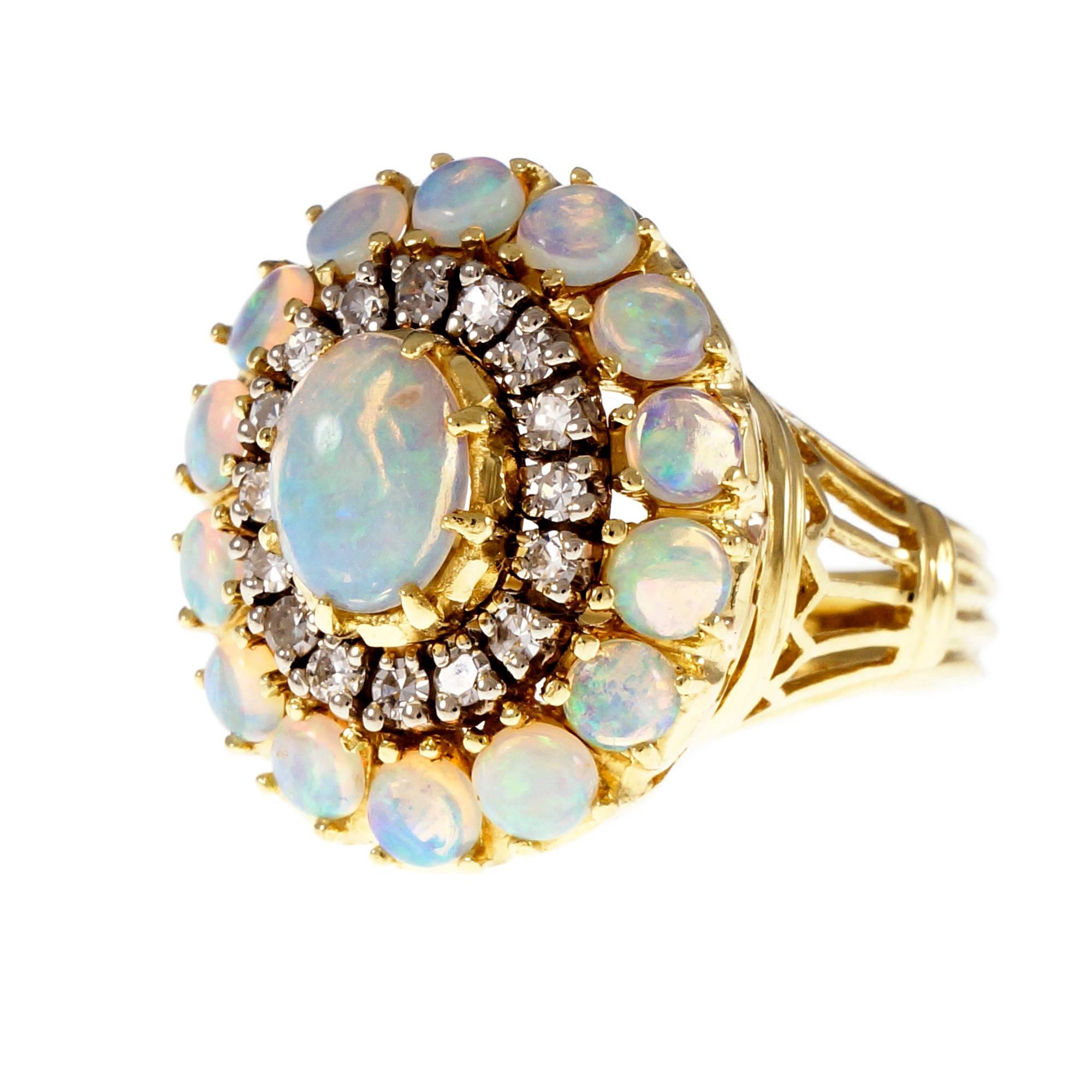 1950’s 18k yellow gold domed cocktail ring with top gem blue green Opals and  full cut Diamonds.

1 oval cabochon blue green translucent Opal, approx. total weight .75cts, 7.75 x 5.84mm
16 round Diamonds, approx. total weight .33cts, H, SI1
14 round