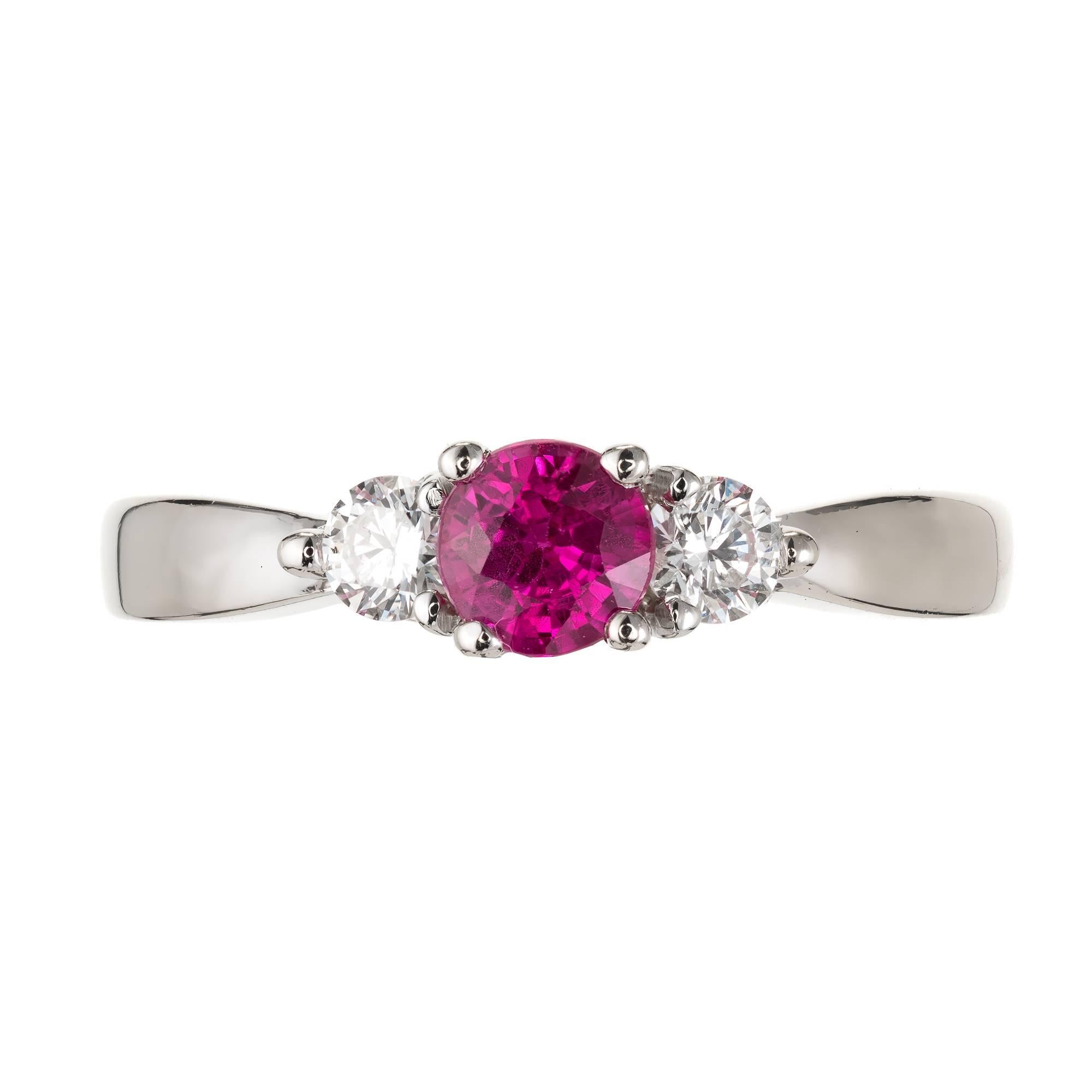 GIA certified purplish pink vivid Sapphire and diamond three-stone engagement ring, in a 14k white gold setting. Natural Sapphire simple heat only. 

1 round brilliant step cut purplish pink Sapphire, approx. total weight .56cts, SI1, natural,