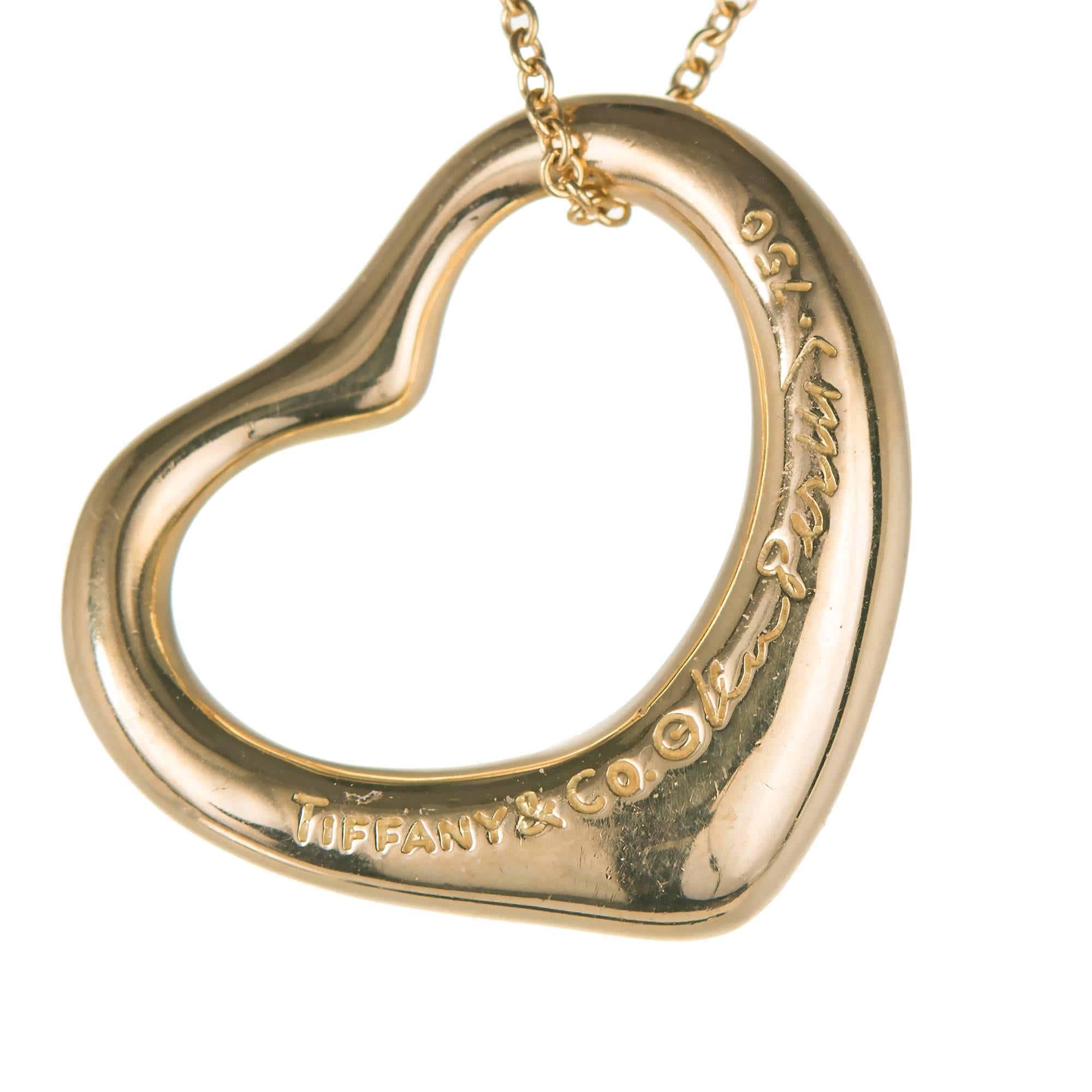 Tiffany & Co Elsa Peretti 18k yellow gold medium Diamond open heart pendant on a Tiffany & Co chain.

28 round full cut Diamonds, .55cts, F – G, VS
18k yellow gold
Tested: 18k
Stamped: 750
Hallmark: Peretti Tiffany & Co, Tiffany & Co