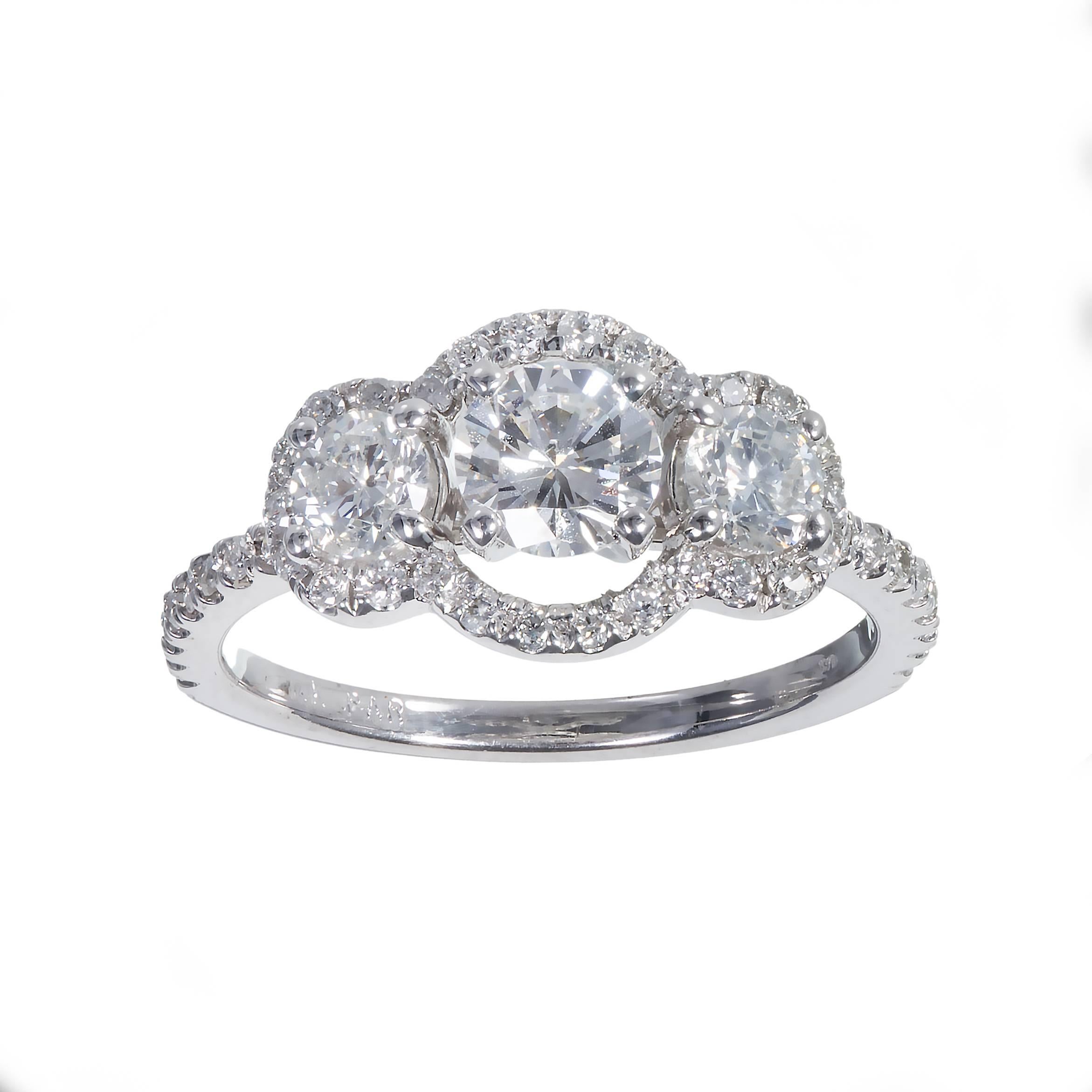 Three stone diamond halo 14k white gold engagement ring. Designed so a band will sit flush against it. EGL certified

1 round diamond E-F VS2 approximately .52 carats EGL Certificate # US313766801D
2 round brilliant cut diamonds F-G SI approximately