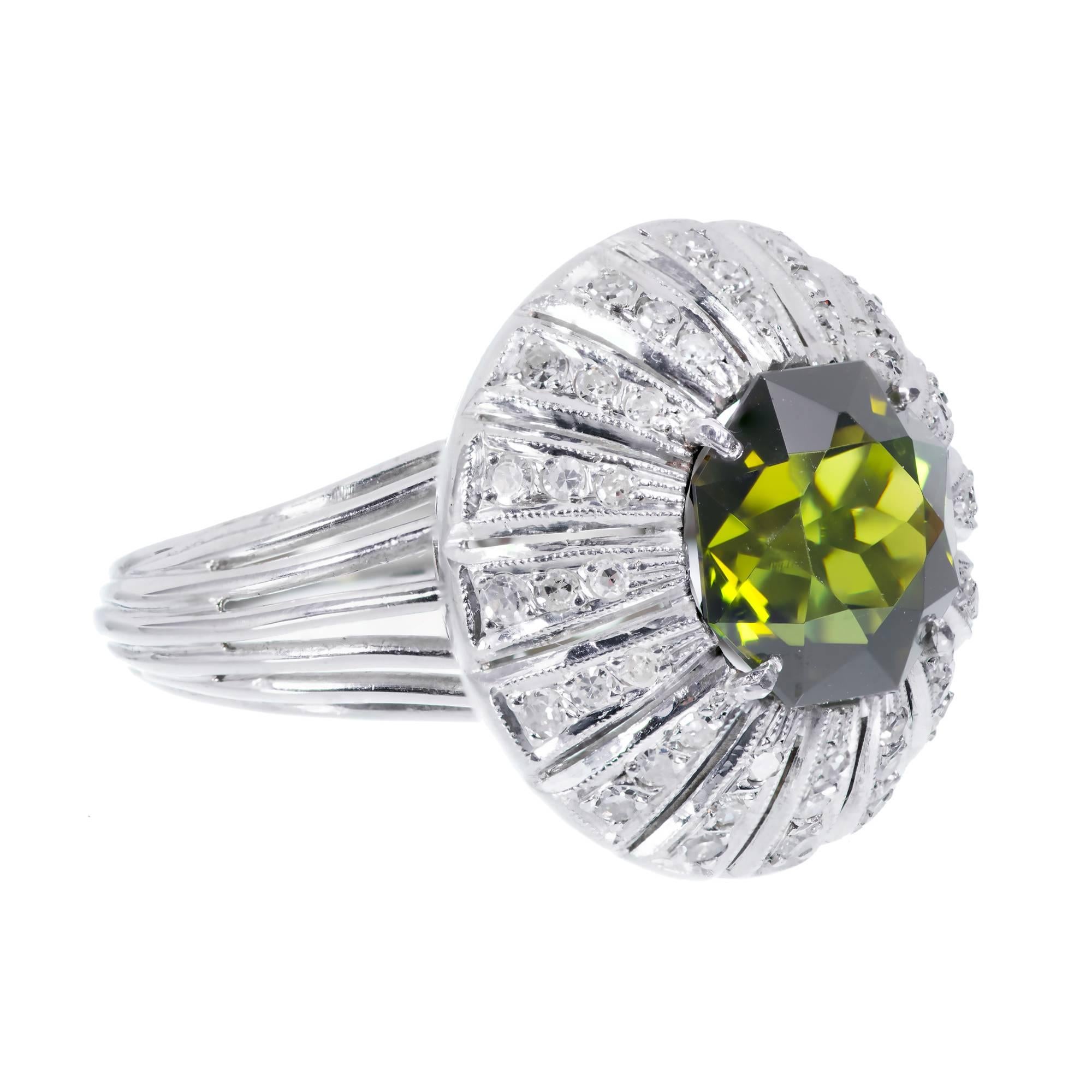 1940’s war years Palladium domed cocktail ring with a cut out raised top set with a bright green 8 sided green tourmaline and white single cut diamonds

1 Octagonal brilliant cut green VS tourmaline 11mm x 11mm approximately 5.75 carats
48 single