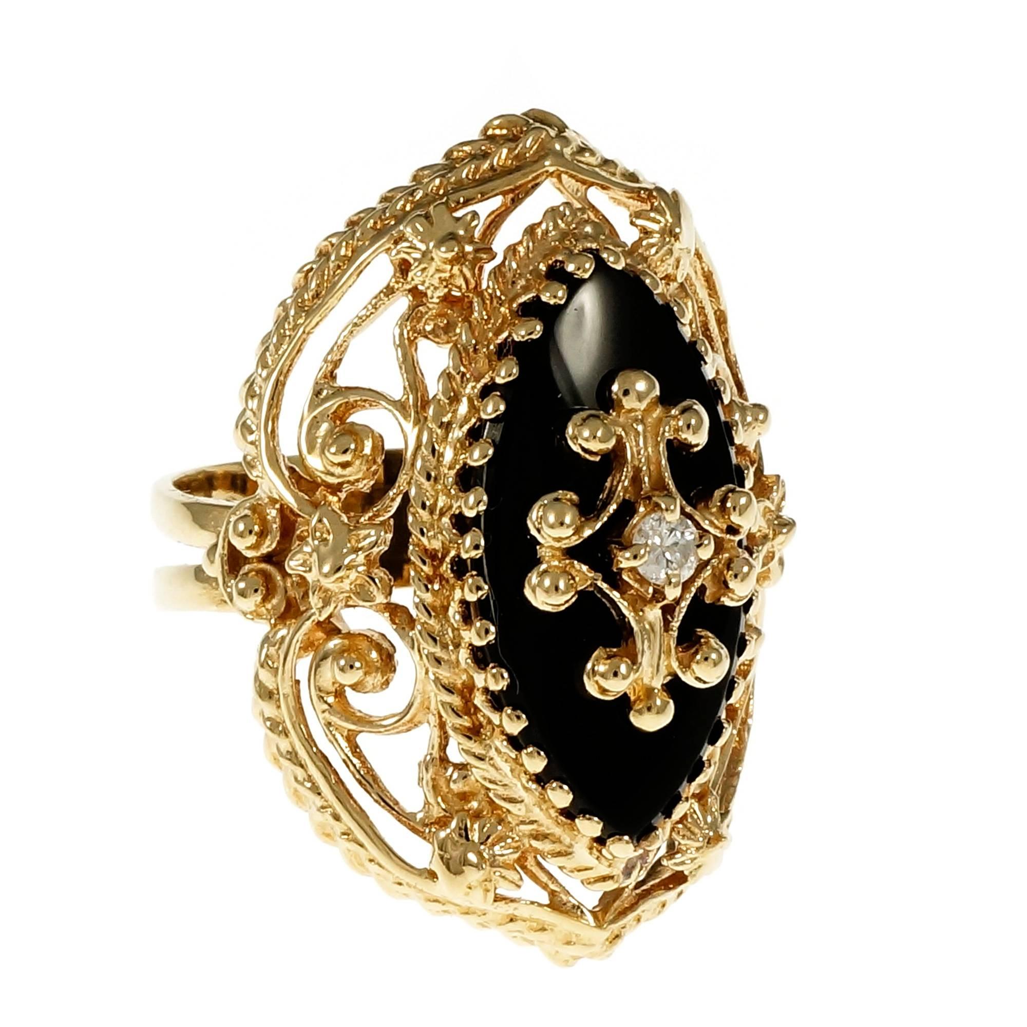 1940-1950 large 14k yellow gold open work ring with a Marquise black Onyx and full cut Diamond center.

1 Marquise black Onyx, 20.39 x 9.61 x 2.30mm
1 round full cut Diamond, approx. total weight .04ct, H, SI1
14k yellow gold
Tested: 14k
9.1