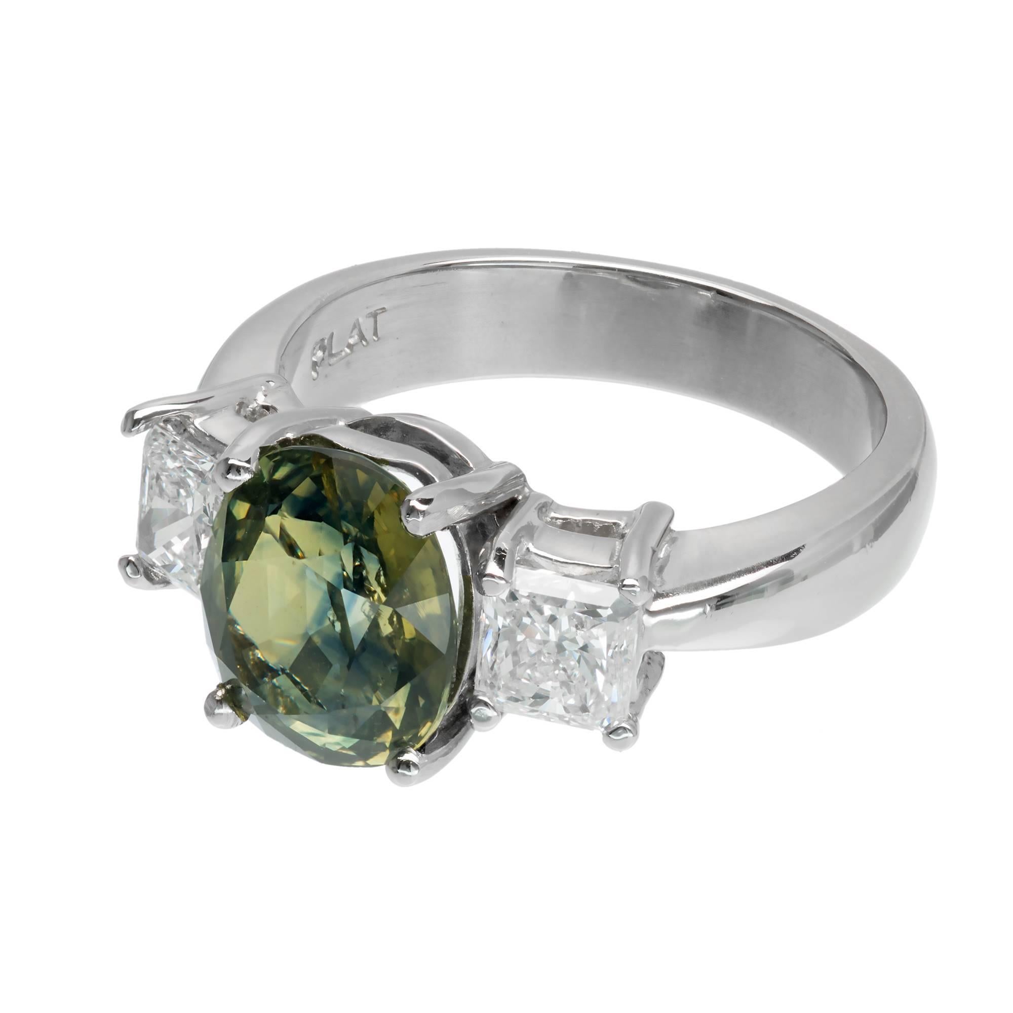  Peter Suchy sapphire and diamond engagement ring. GIA certified natural yellow green cushion cut Sapphire center stone, set in a three-stone platinum setting with 2 square radiant cut side diamonds. Created in the Peter Suchy Jewelers Workshop. 

1