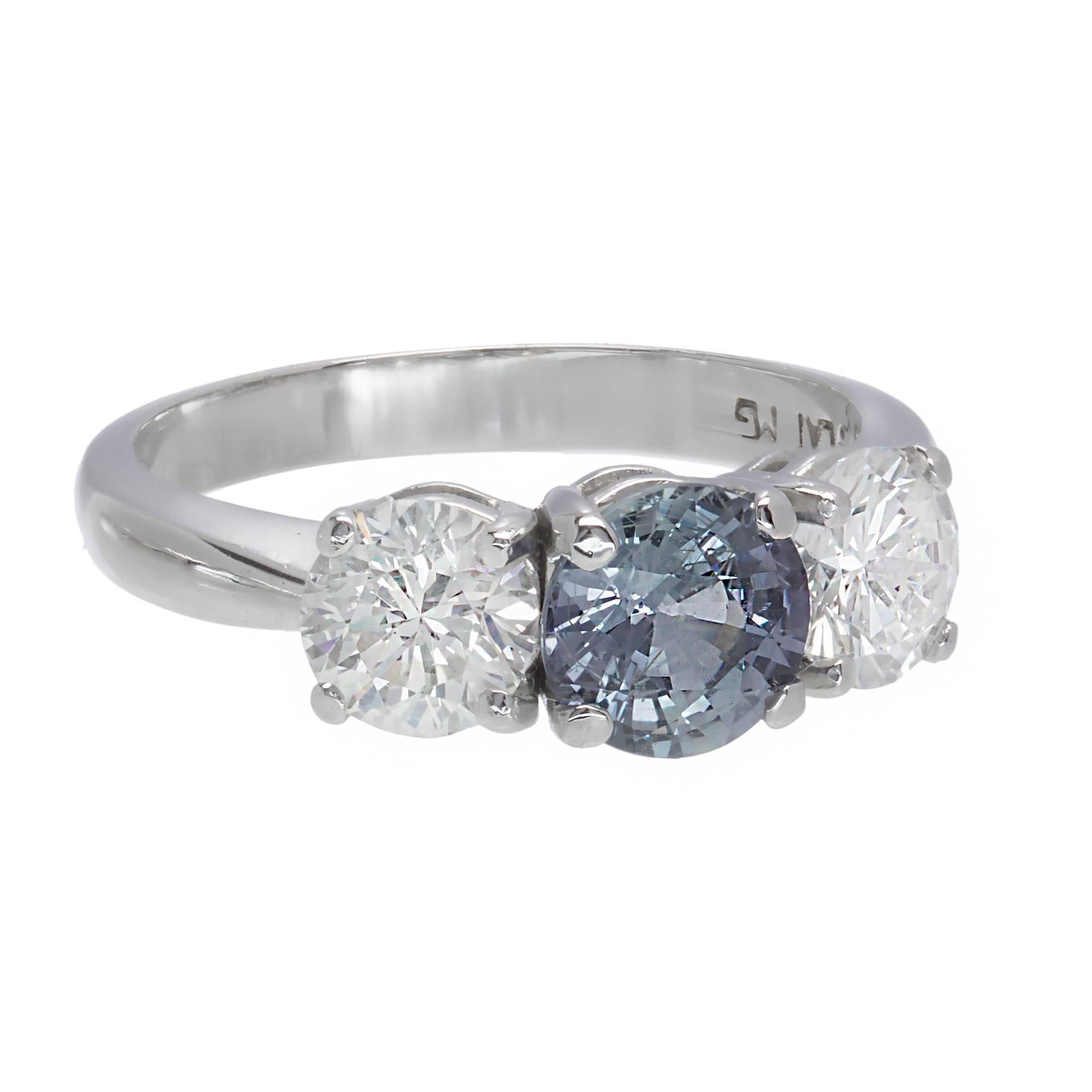 Peter Suchy GIA certified natural no heat color change Sapphire engagement ring. Sapphire changes color in different lights from grey blue to grey purple. Also, set with 2 round brilliant cut Diamonds in a three-stone platinum setting

1 round color