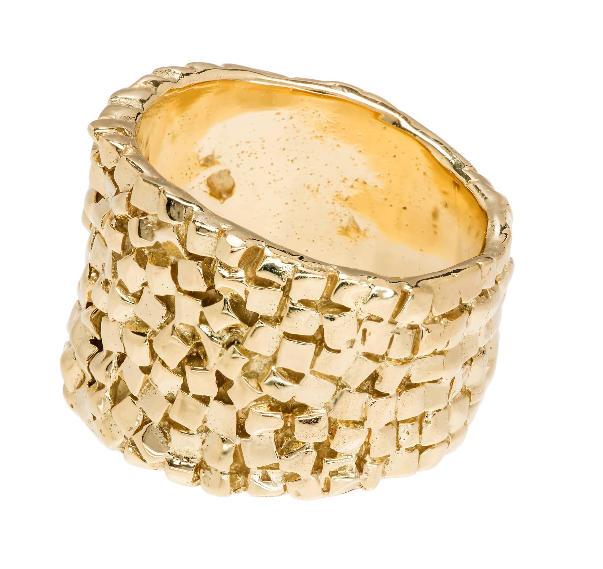 Custom made woven design 18k yellow gold ring.

18k yellow gold
14.8 grams
Width at top: 14.59mm
Height at top: 2.52mm
Width at Bottom: 10.40mm
Size 5.5 and not easily sized

