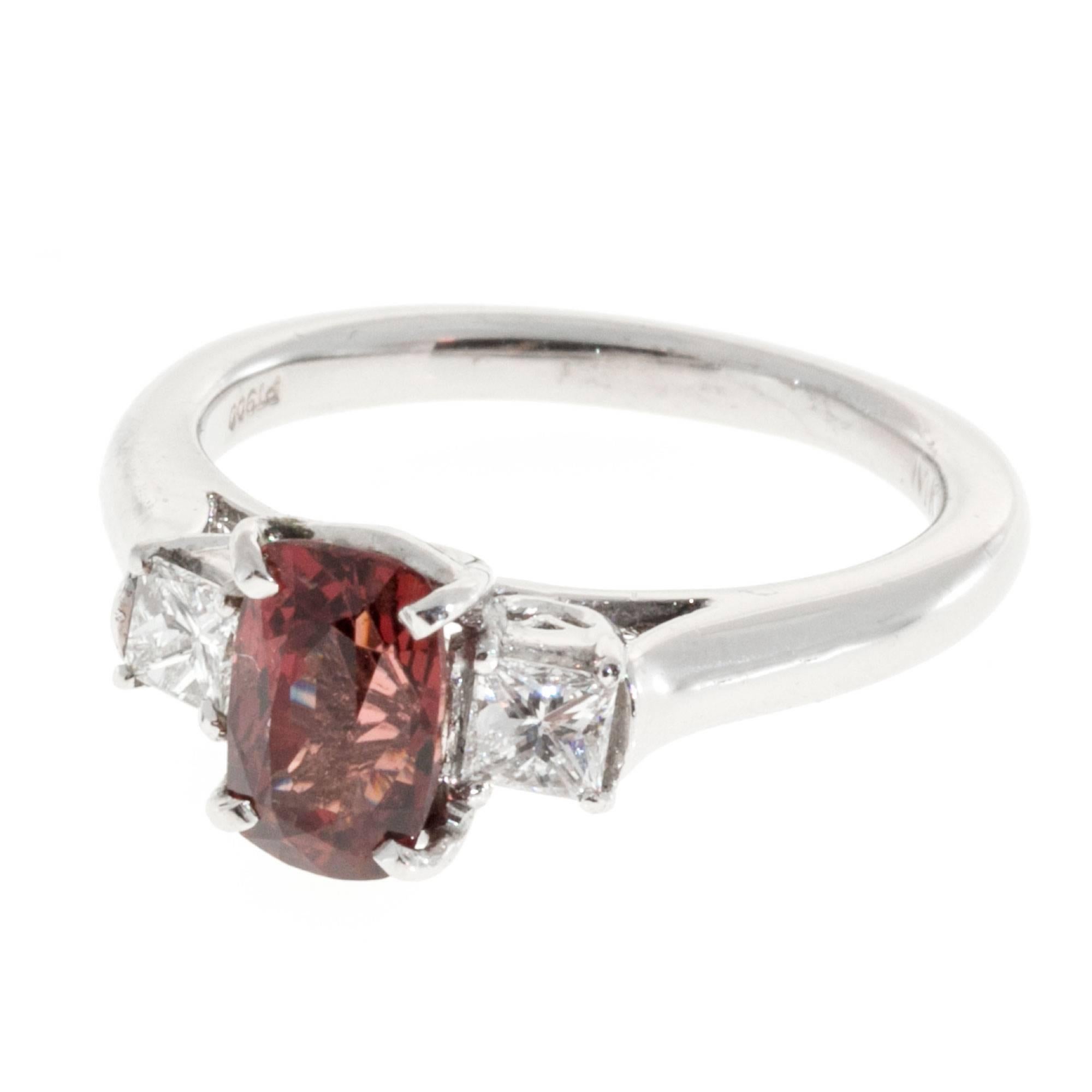 Red natural untreated Spinel and diamond three-stone engagement ring. Elongated spinel with two princess cut side diamonds in a platinum setting.

1 cushion cut natural orange red Spinel, approx. total weight 1.37cts, SI1, 7.67 x 4.98 x 4.30mm, GIA