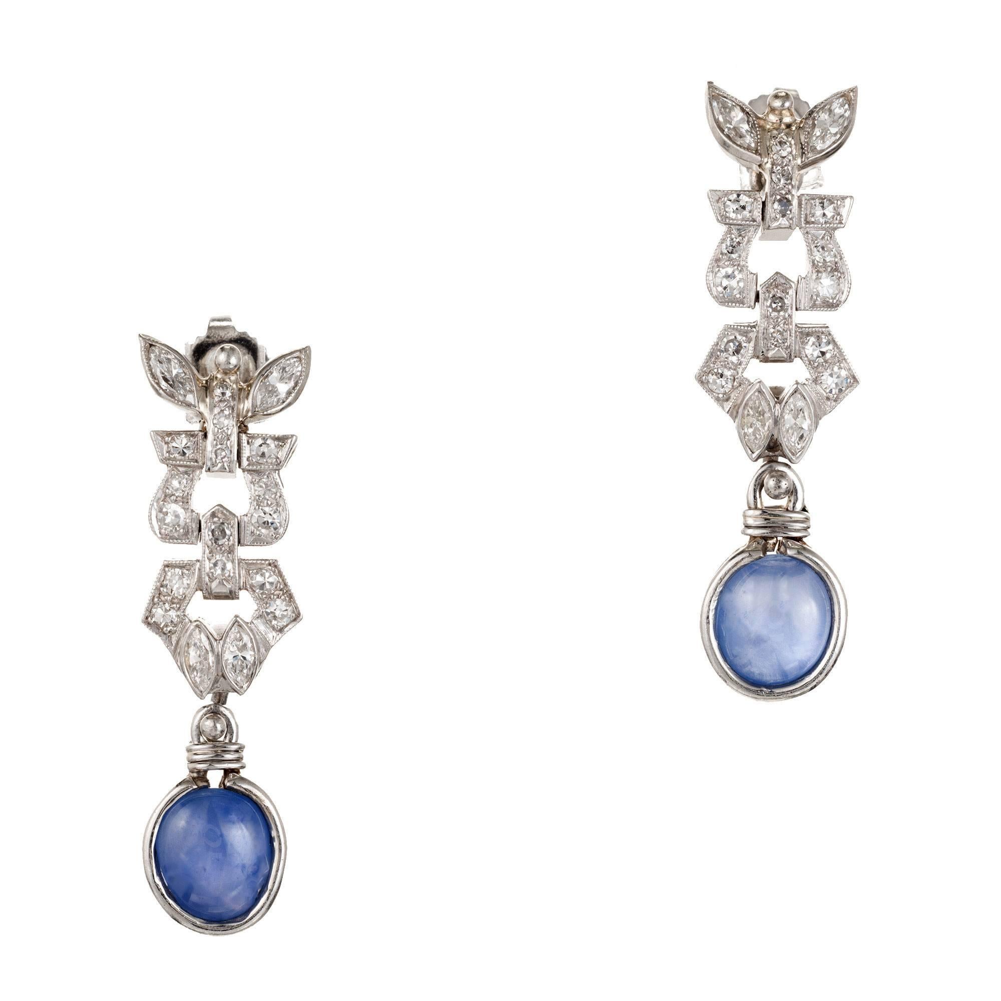 4.75 Carat sapphire and diamond dangle earrings. Made in platinum with two oval cabochon sapphires and 38 round accent diamonds.  

2 cabochon sapphires 4.75cts, medium blue color.
38 round diamonds .75cts, VS2, H.
Tested Platinum.
10.3 grams.
1 3/8