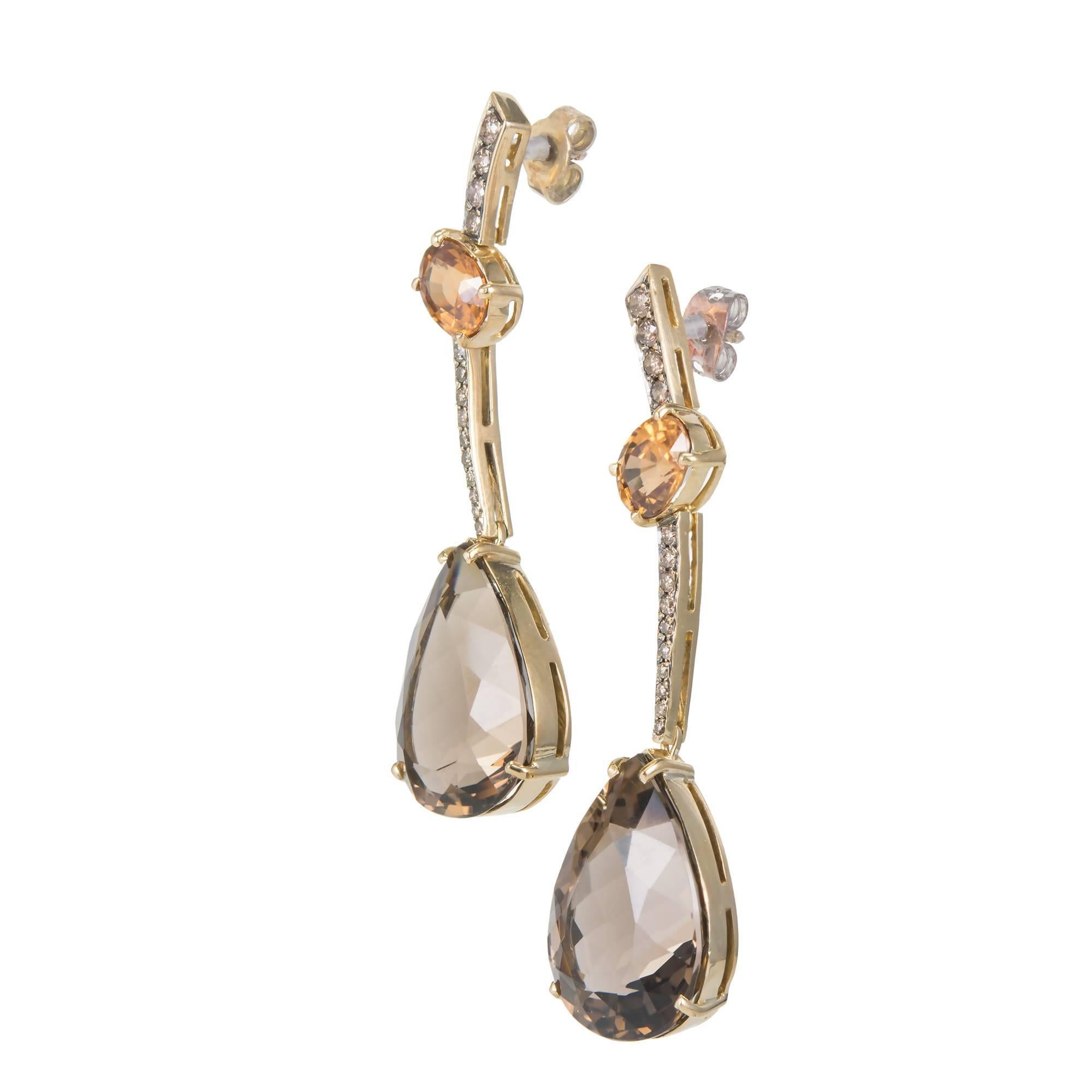 Citrine, smoky Quartz and diamond dangle drop earrings, in 14k yellow gold. 

26 round Champagne or light brown color Diamonds, approx. total weight .60cts, SI
2 oval golden yellow Citrines, approx. total weight 2.58cts, SI, 6 – 8.5mm
2 pear shape