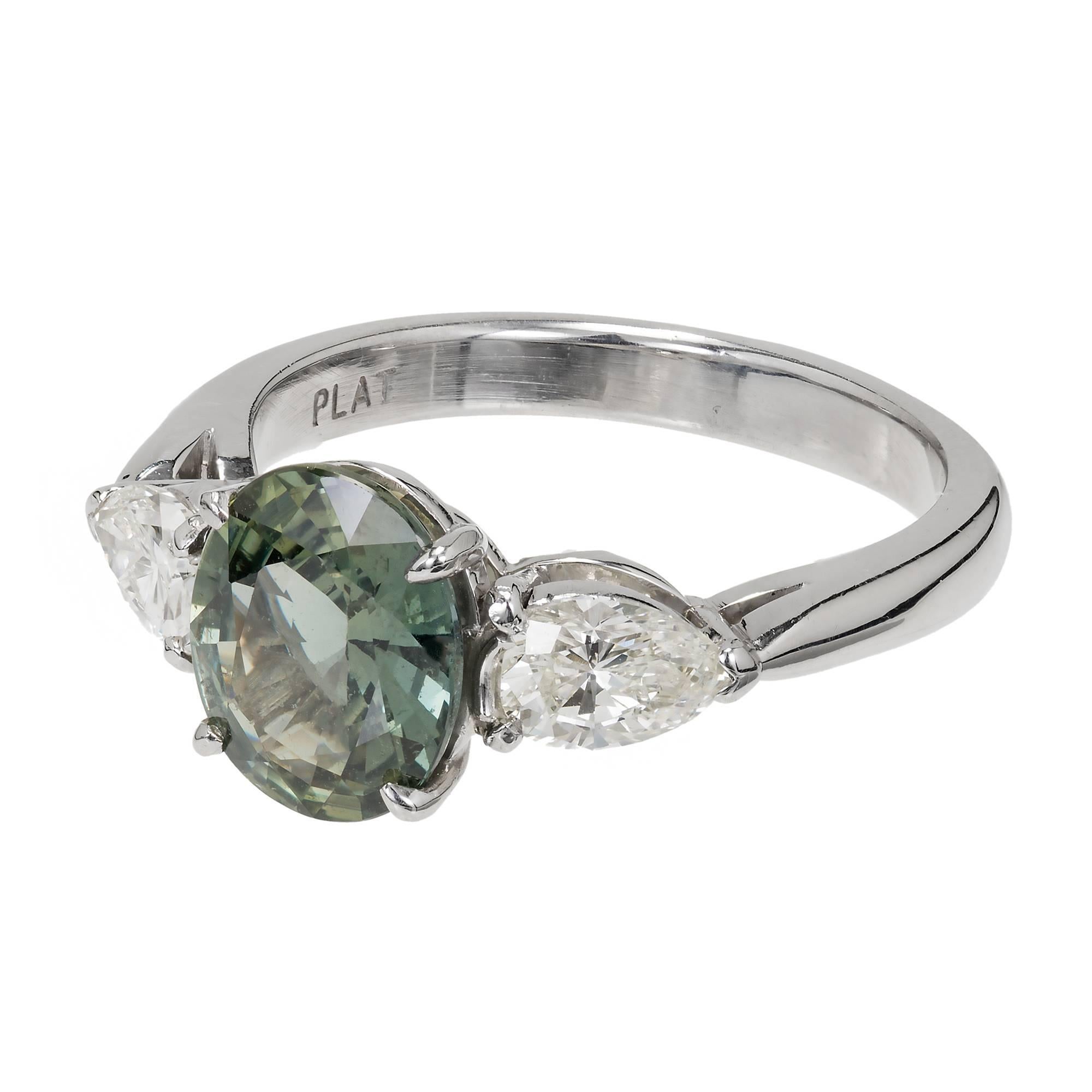 Peter Suchy AGL certified natural no heat 2.06ct oval Sapphire of natural grey green color.  Set in a Platinum three-stone setting with two pear shape sparkly side Diamonds. 

1 oval greyish green Sapphire, approx. total weight 2.06cts, SI1, AGL