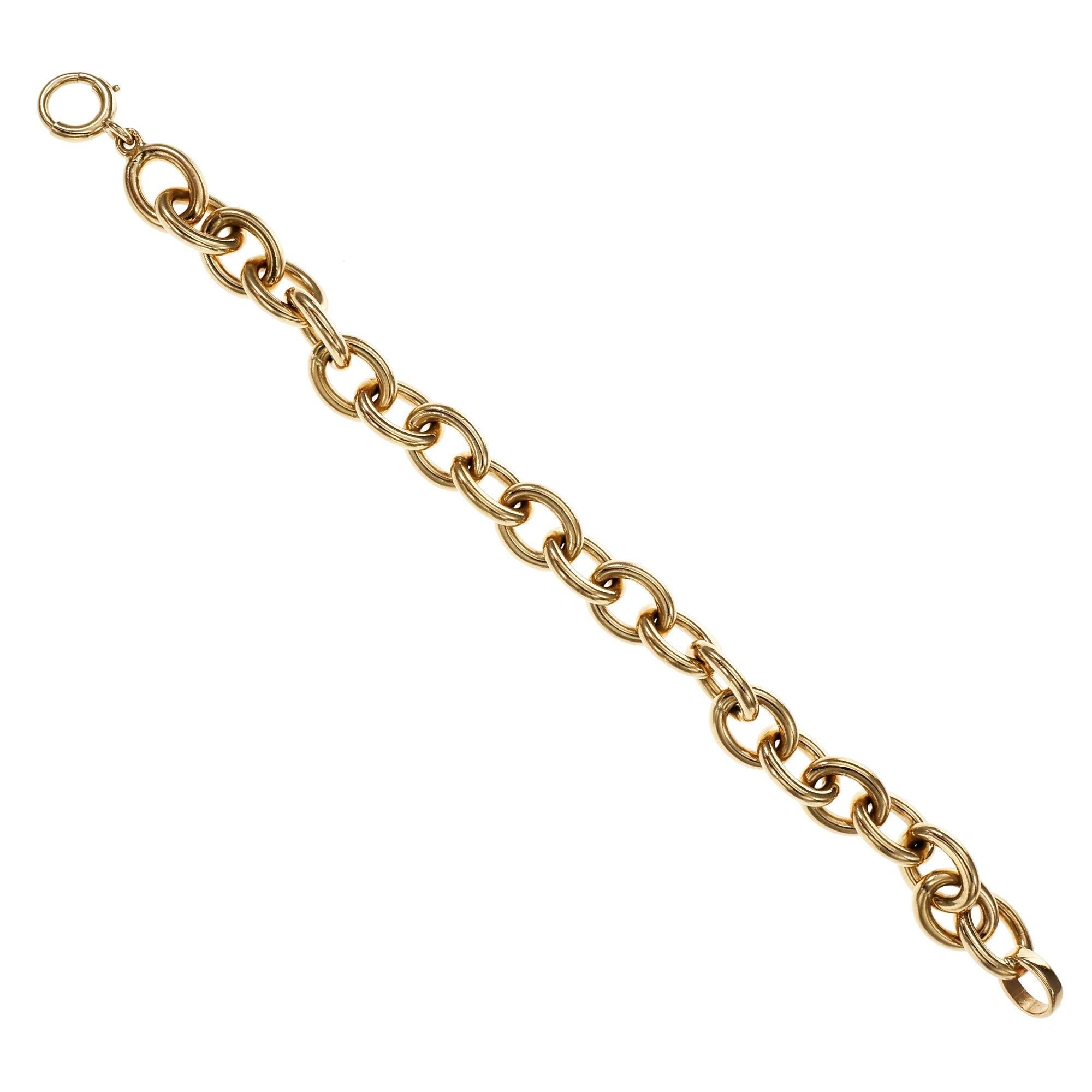 Solid oval link 14k yellow gold with original spring ring bracelet. Circa 1940s.

14k yellow gold
39.5 grams
Tested and stamped: 14k
Length: 7.25 inches – Width: 10.19mm – Depth: 2.50mm
