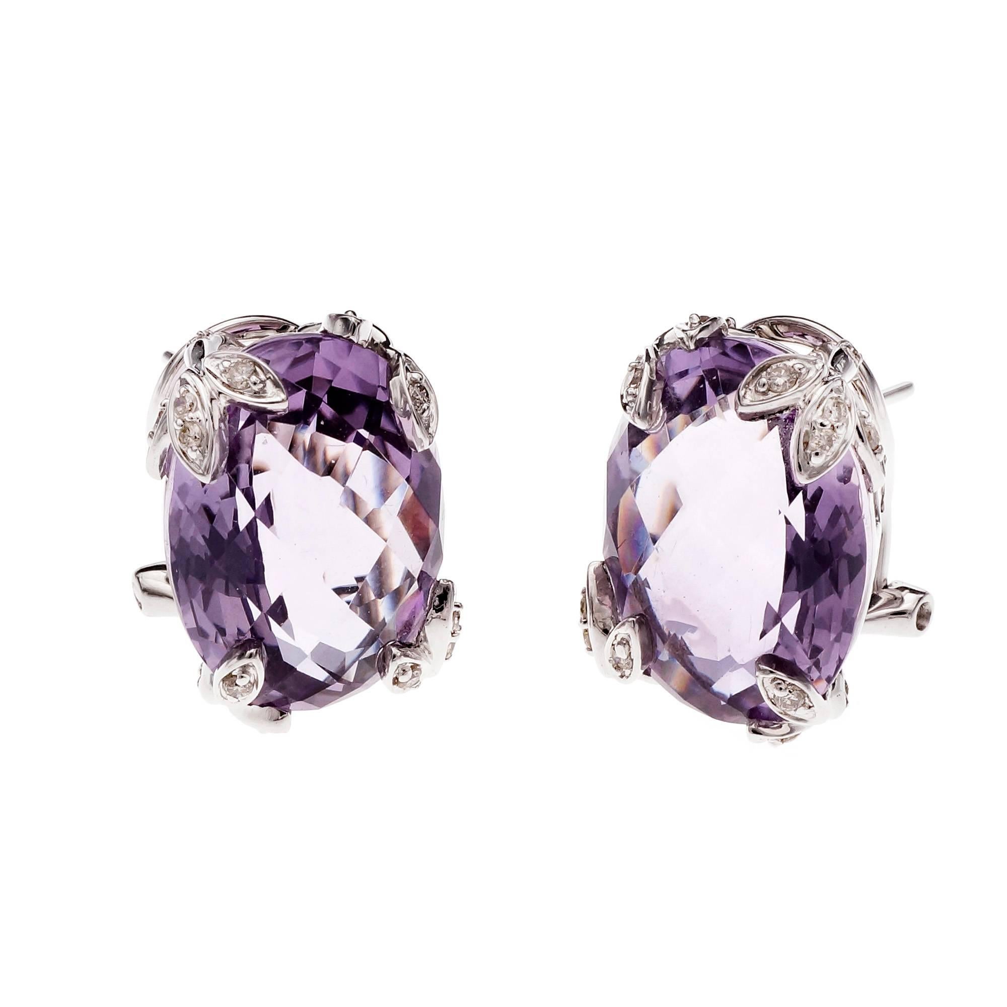 Bright medium purple domed faceted Amethyst Diamond white gold earrings.

2 oval medium purple Amethyst, approx. total weight 16.00cts, VS, 15.32 x 12.08 x 8.46mm
40 round Diamonds, approx. total weight .28cts
14k white gold
Tested: 14k
Stamped: 14k