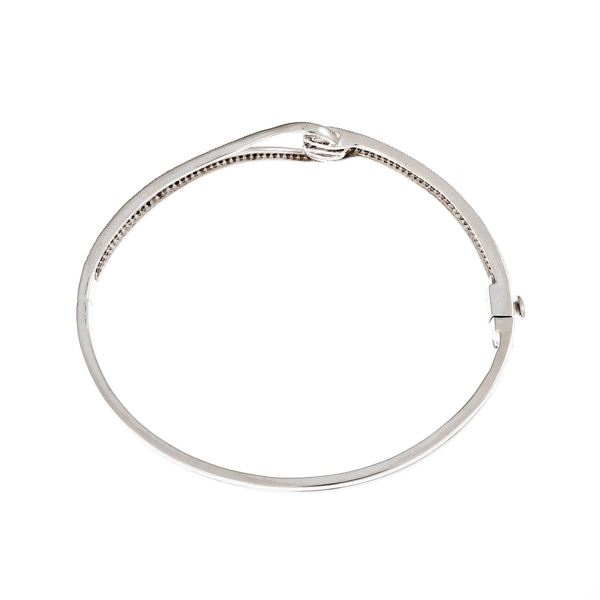 Estate hinged bangle bracelet micro pavé set with bright single cut Diamonds. Built in catch with side lock safety.

14k white gold
161 single cut Diamonds, approx. total weight .85cts, H – I, VS – SI
Width at top: 11.47mm
Height at top: