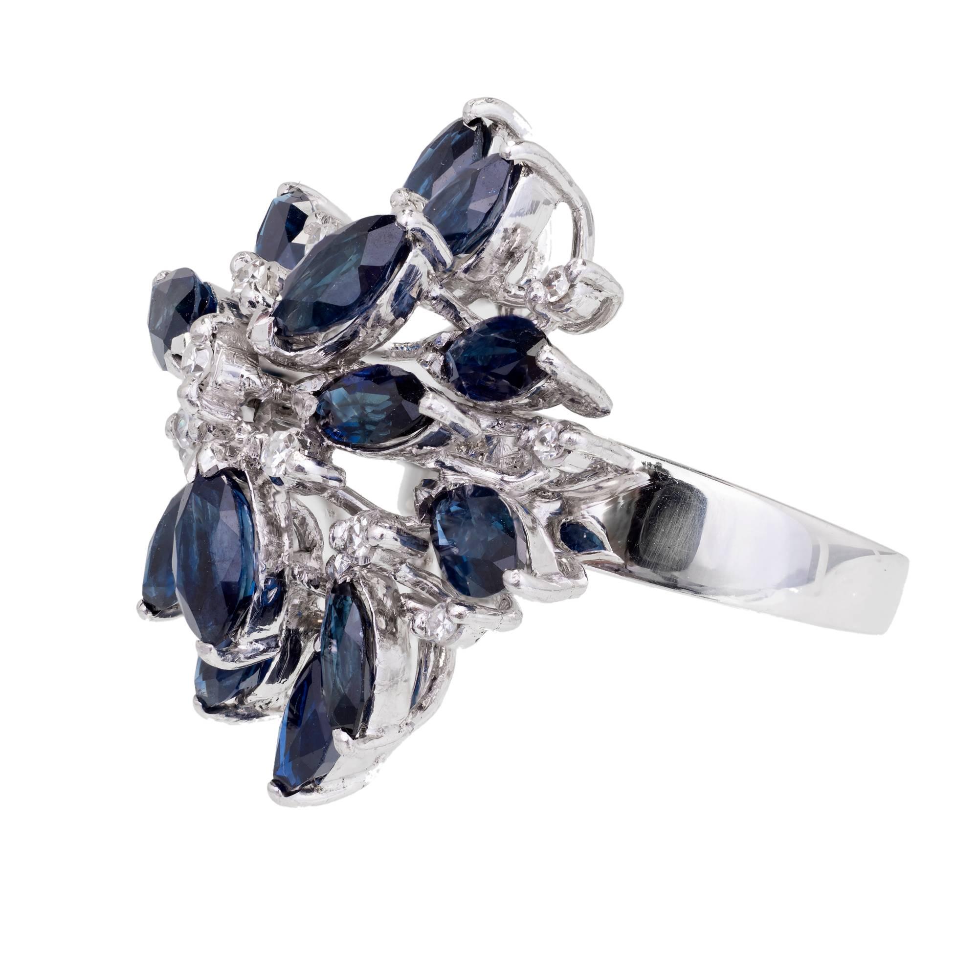 1960’s handmade wire top dome ring set with bright blue Marquise Sapphires and round Diamonds.

15 Marquise blue Sapphires, approx. total weight 5.25cts, SI, 6 x 3mm
14 round single cut Diamonds, approx. total weight .15cts, H, VS
18k white gold
8.6